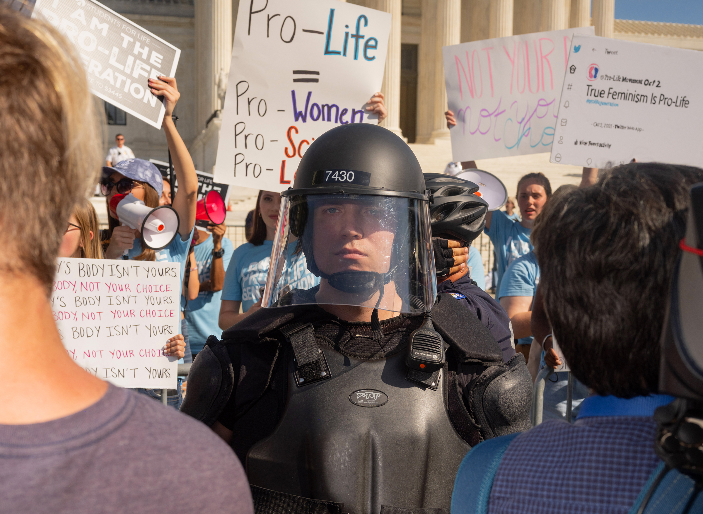 Protesters and counter-protestors meet outside of the Supreme Court at the Women's March and Rally for Abortion Justice in Washington, DC, on October 2, 2021.  Counter-protestors are behind the gates on the side of the Supreme Court, protected by a swat 