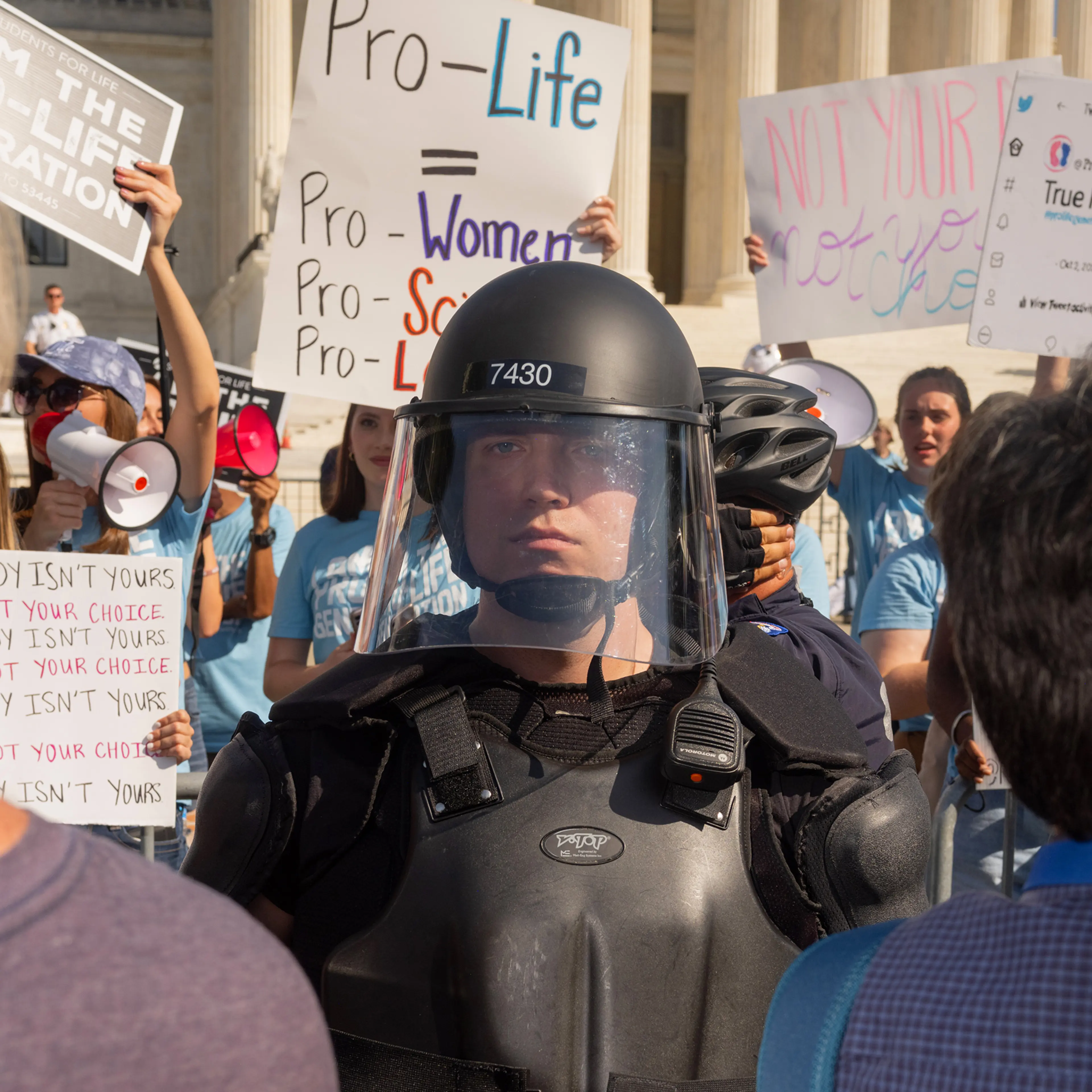 Protesters and counter-protestors meet outside of the Supreme Court at the Women's March and Rally for Abortion Justice in Washington, DC, on October 2, 2021. Counter-protestors are behind the gates on the side of the Supreme Court, protected by a swat
