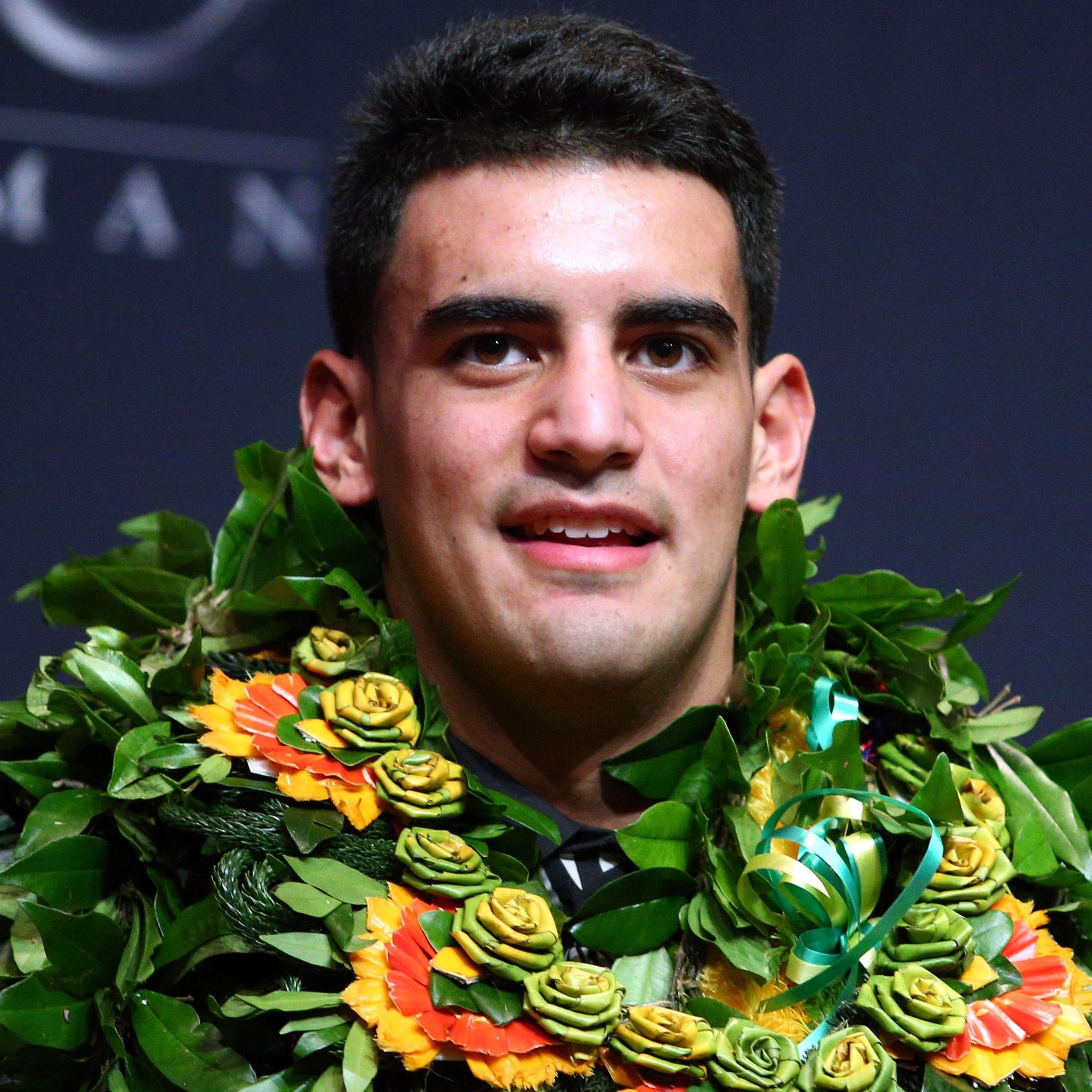 Oregon Ducks quarterback Marcus Mariota answers questions during a press conference after winning the Heisman Trophy