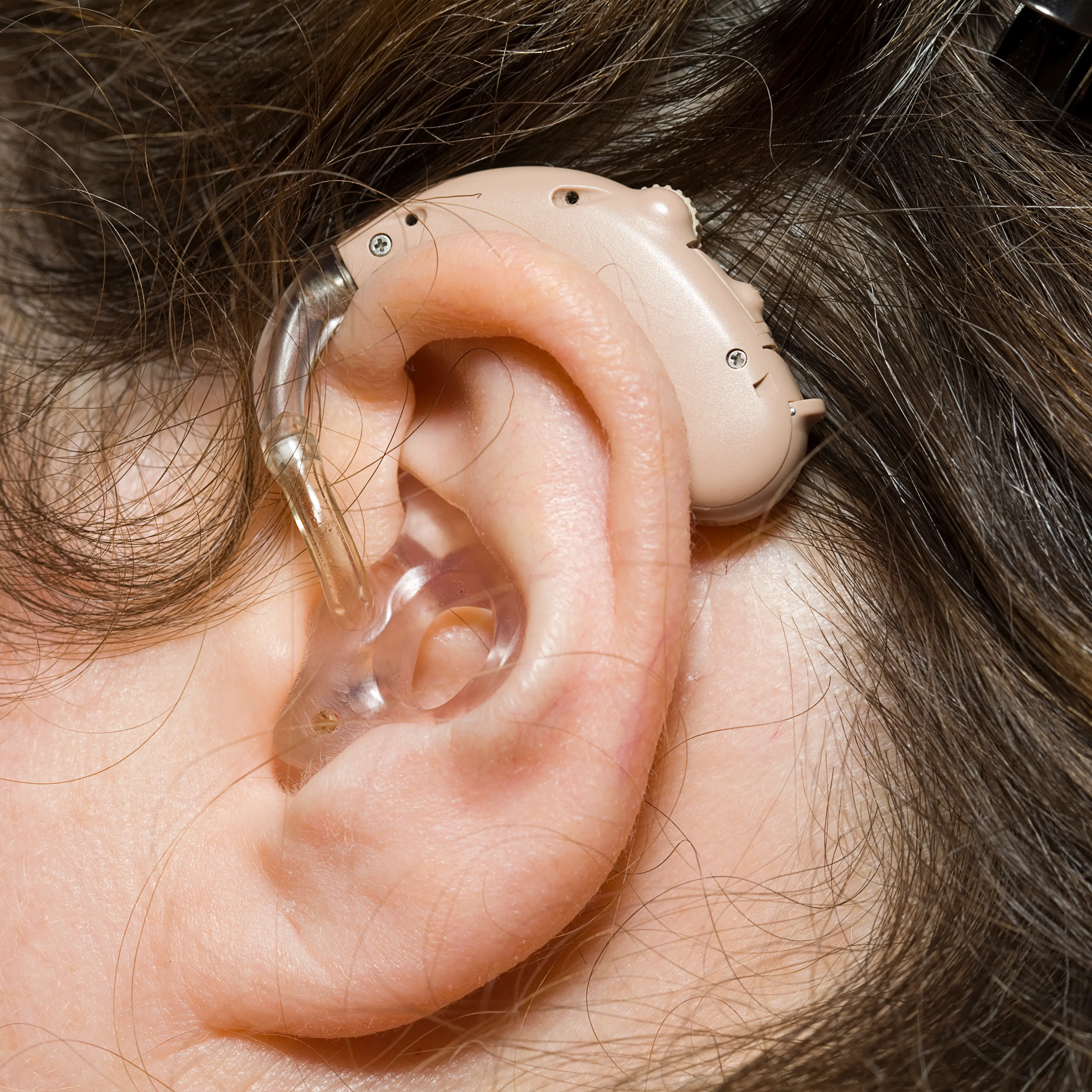 Close up of woman wearing digital hearing aid