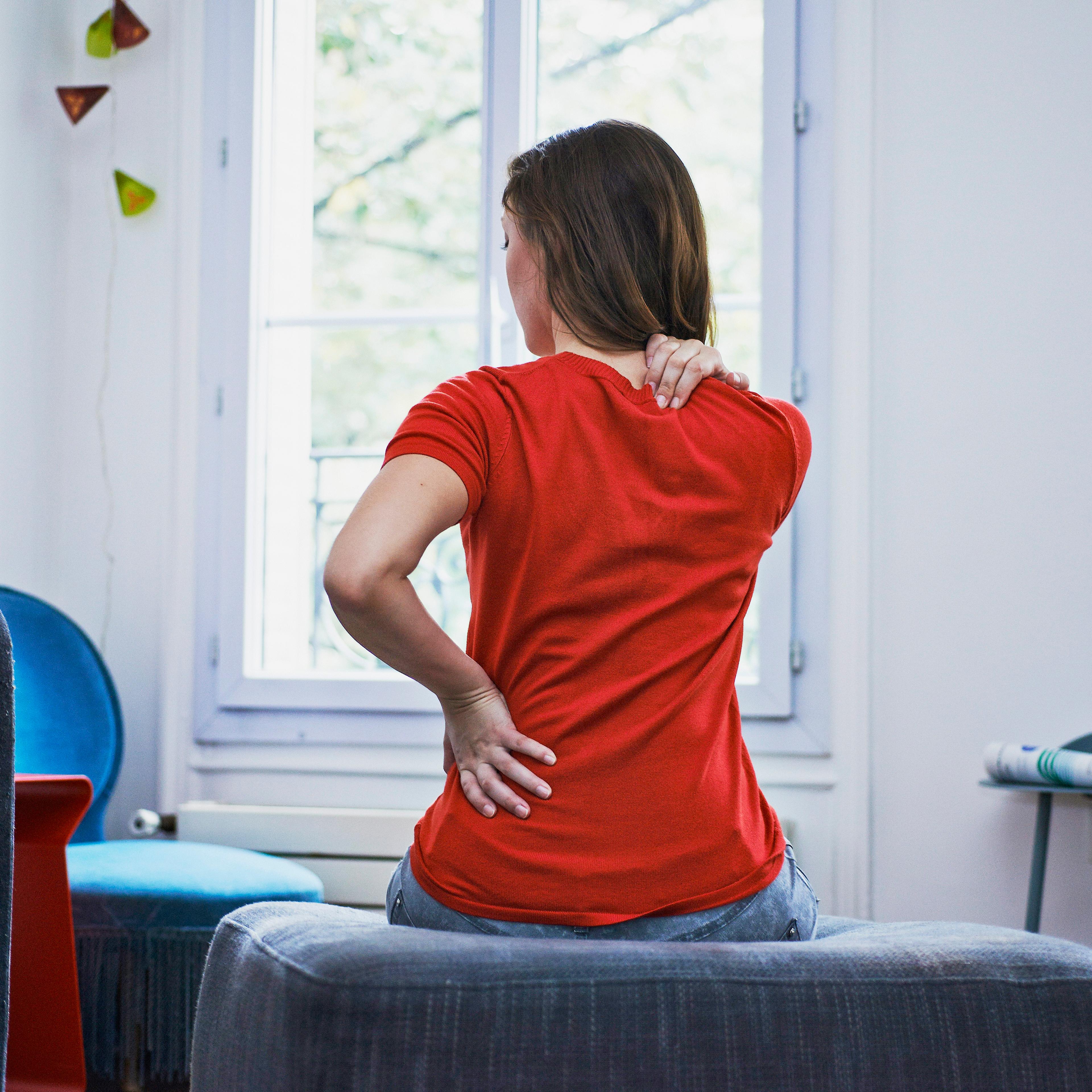 Woman suffering from back pain. France