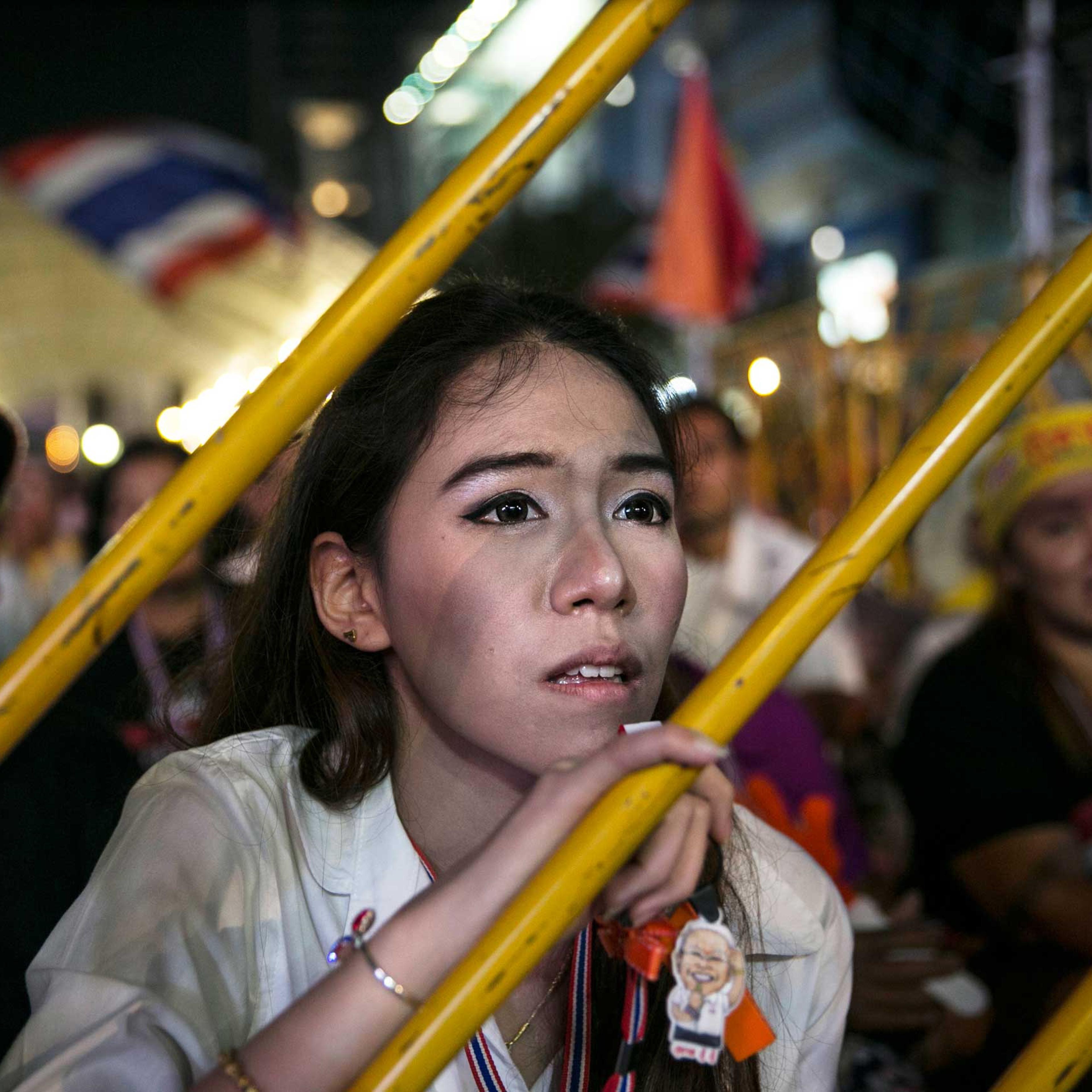 An anti-government protestor listens as leader Suthep Thaugsuban speaks about the elections during his daily speech Feb. 3, 2014 in Bangkok,Thailand.