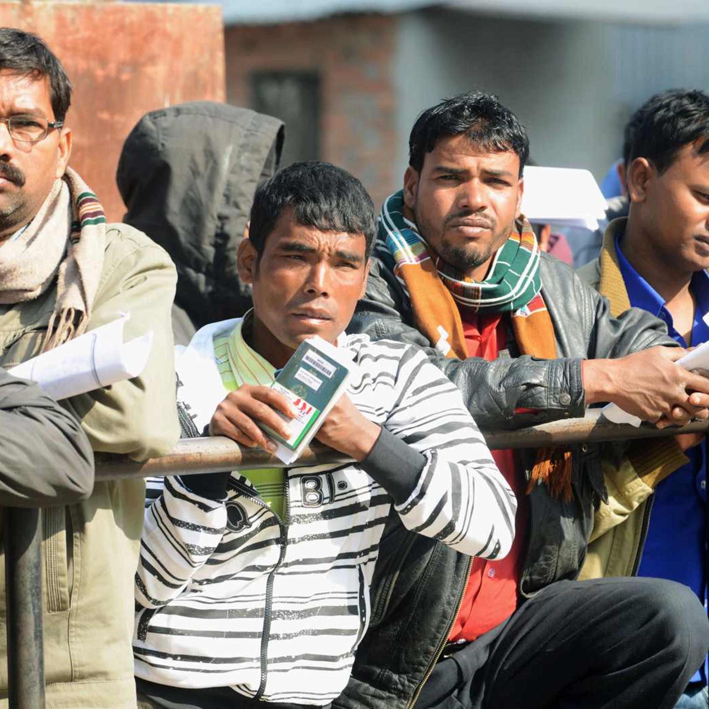 Nepalese migrant workers queue to receive official documents in order to leave Nepal from the Labour department in Kathmandu on January 27, 2014.
