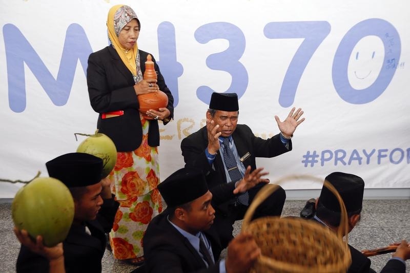 Ibrahim Mat Zin performs a ritual to help find the missing Malaysia Airlines MH370 at Kuala Lumpur International Airport.