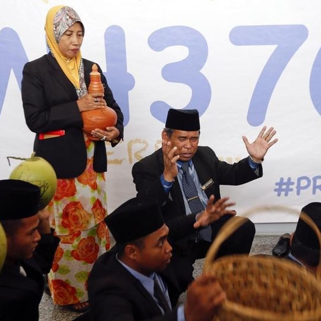Ibrahim Mat Zin performs a ritual to help find the missing Malaysia Airlines MH370 at Kuala Lumpur International Airport.