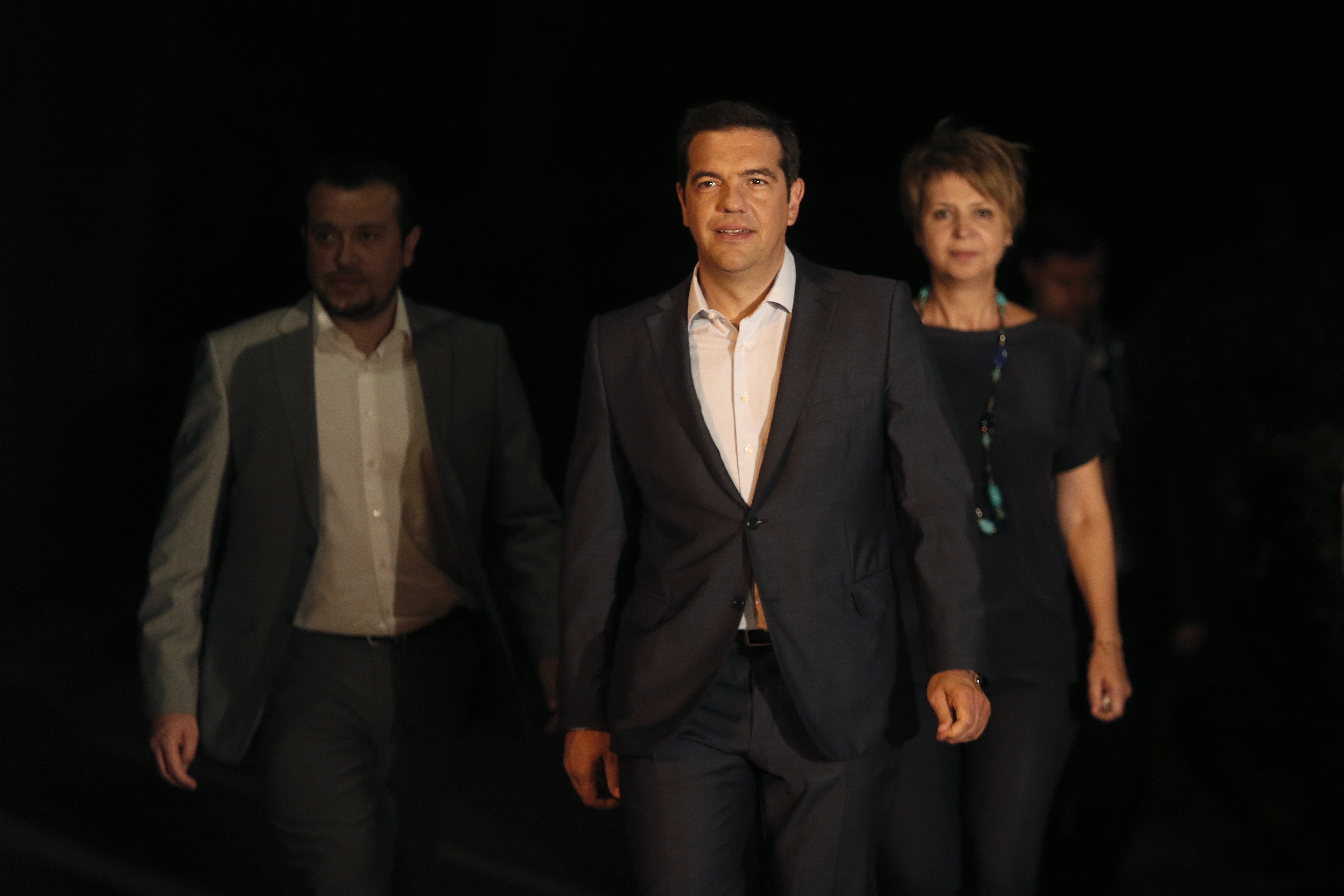 Greek Prime Minister Alexis Tsipras, center, leaves the Presidential palace after a meeting with Greek President Prokopis Pavlopoulos, in Athens, on Aug. 20, 2015.