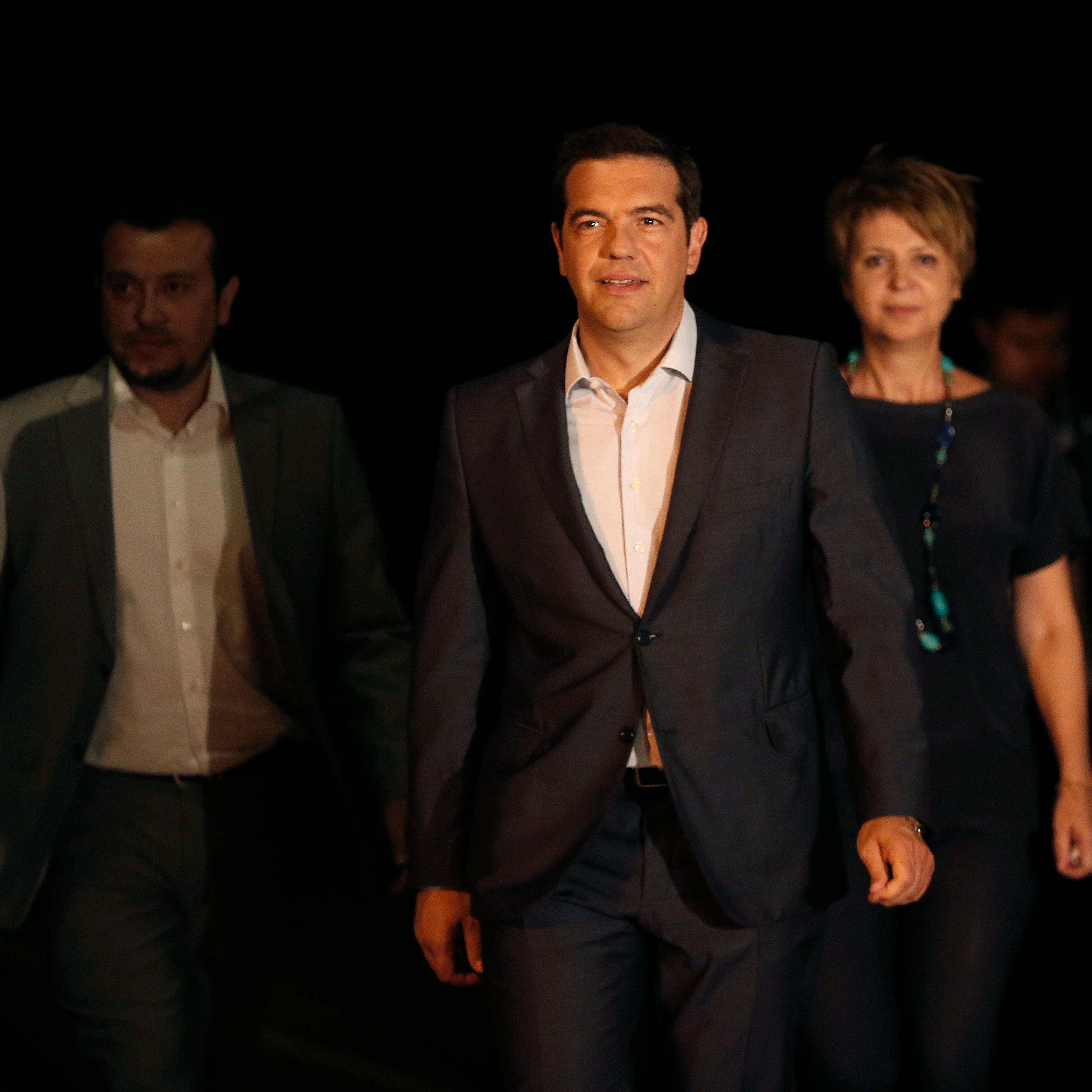 Greek Prime Minister Alexis Tsipras, center, leaves the Presidential palace after a meeting with Greek President Prokopis Pavlopoulos, in Athens, on Aug. 20, 2015.