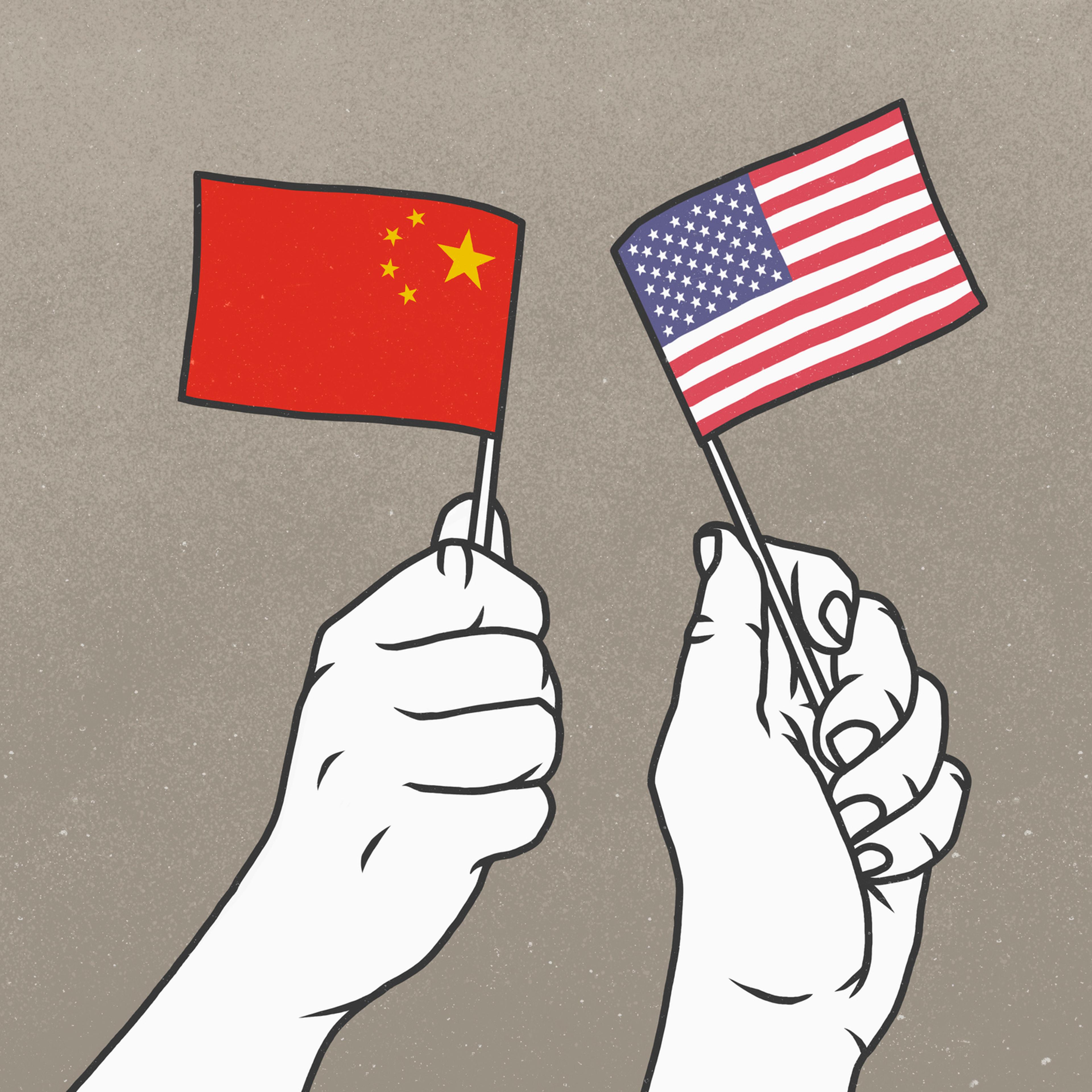 Hands waving small American and Chinese flags