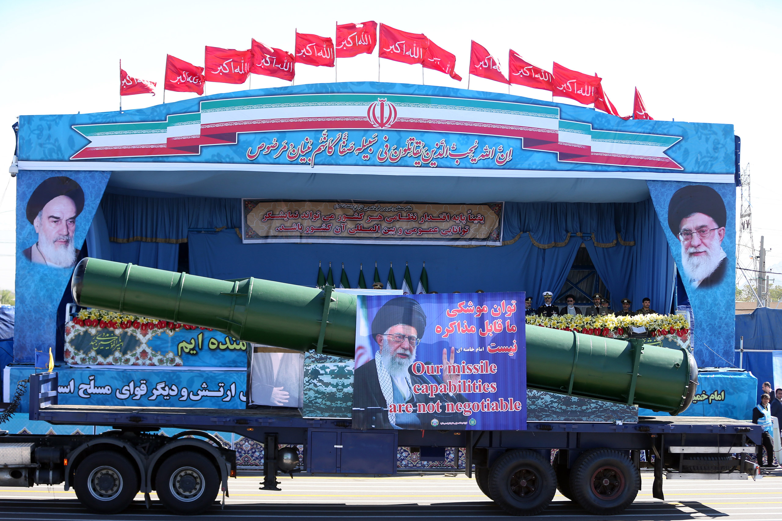 In front of the portraits of supreme leader Ayatollah Ali Khamenei, right, and late revolutionary founder Ayatollah Khomeini, left, a long-range, enhanced S-200 missile is displayed by Iran's army during a parade marking National Army Day at the mausoleu