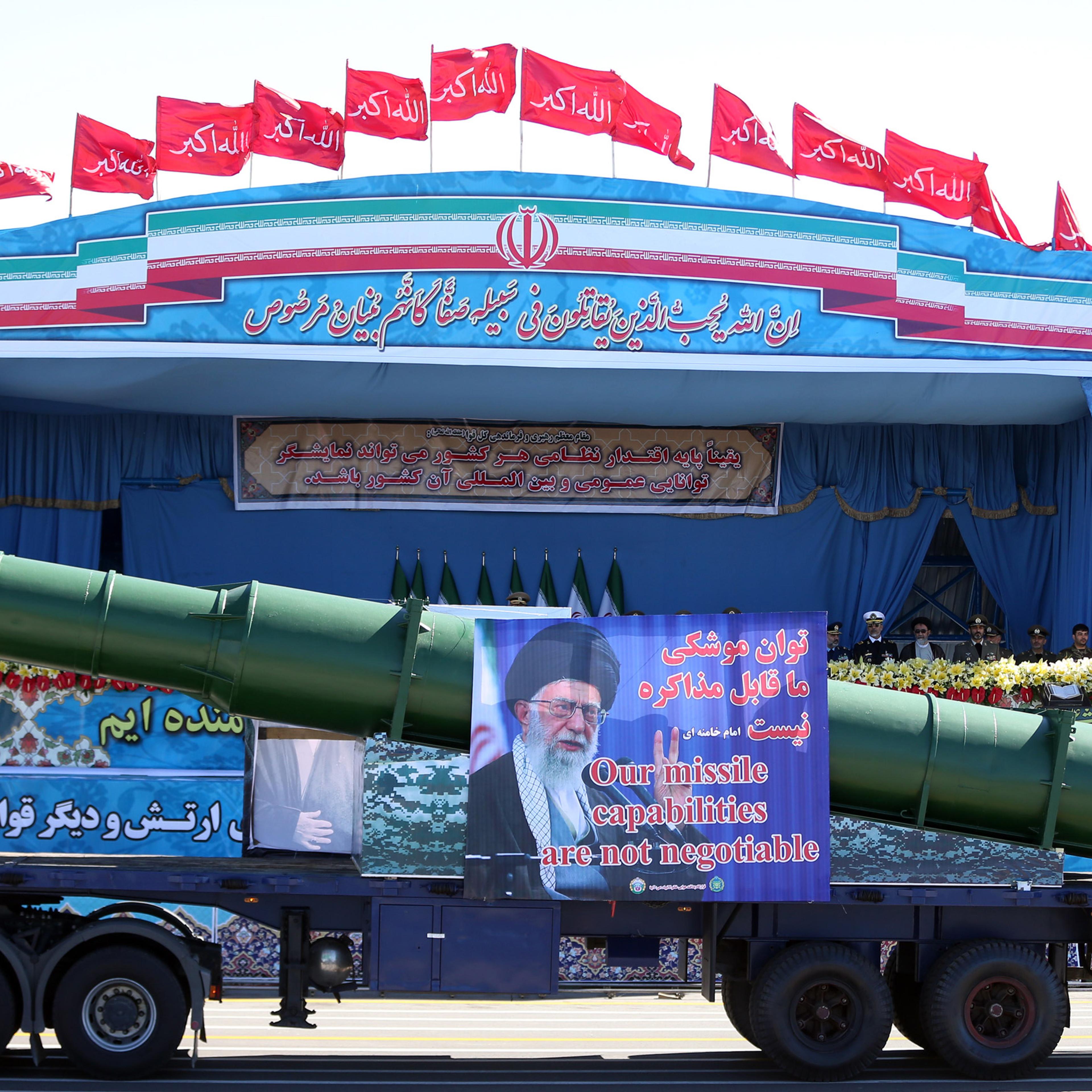 In front of the portraits of supreme leader Ayatollah Ali Khamenei, right, and late revolutionary founder Ayatollah Khomeini, left, a long-range, enhanced S-200 missile is displayed by Iran's army during a parade marking National Army Day at the mausoleu