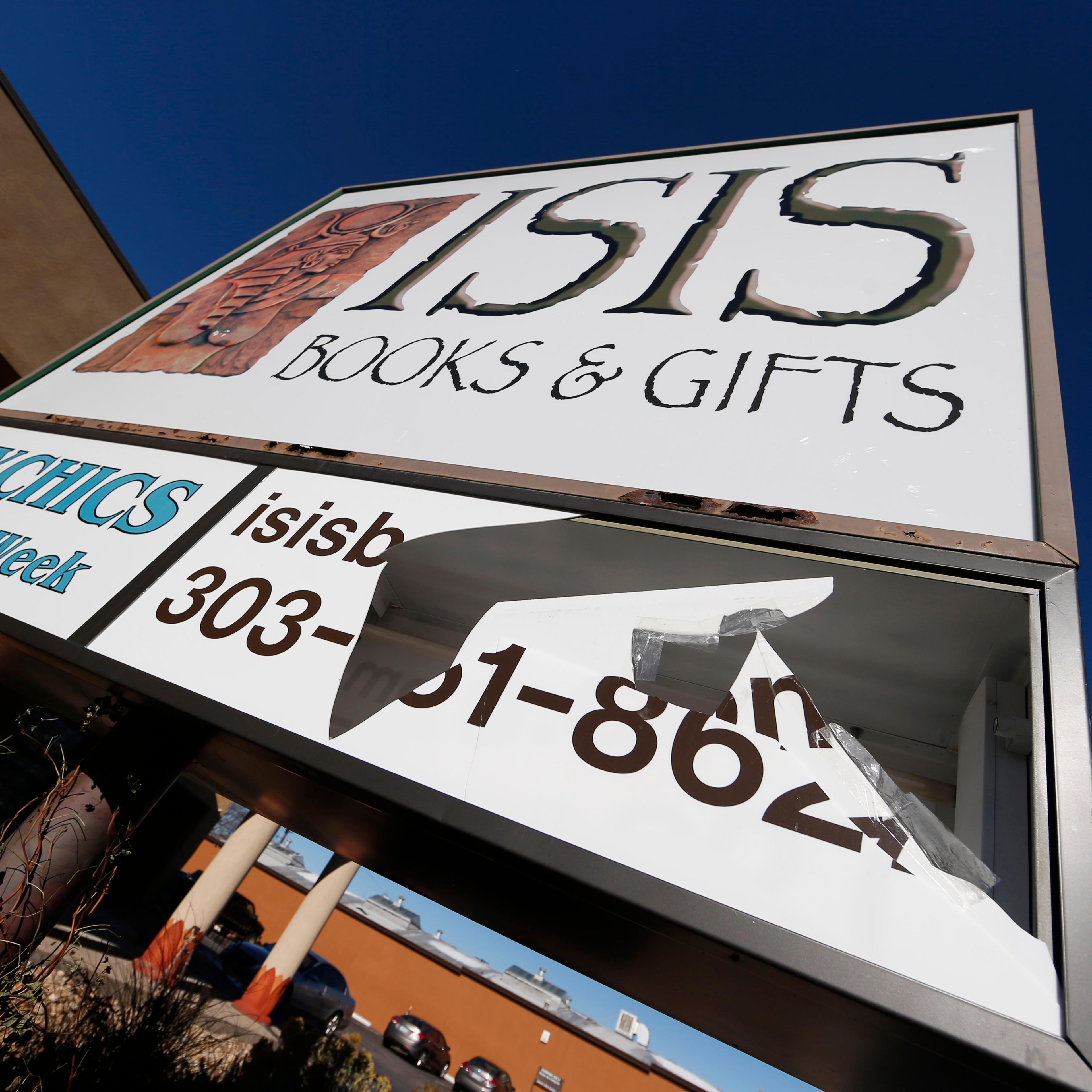 A panel of the sign outside Isis Books and Gifts is shown broken on Nov. 18, 2015, in Englewood, Colo.