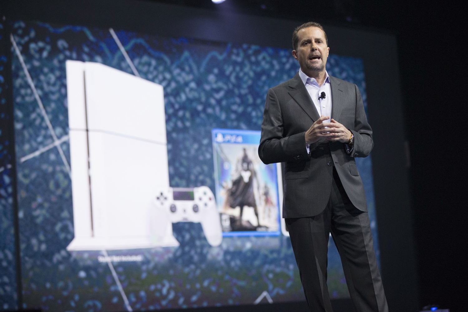 Andrew House, President and Group CEO of Sony Computer Entertainment, presents a white PlayStation 4 during a media briefing before the opening day of the Electronic Entertainment Expo, or E3, at the Memorial Sports Arena