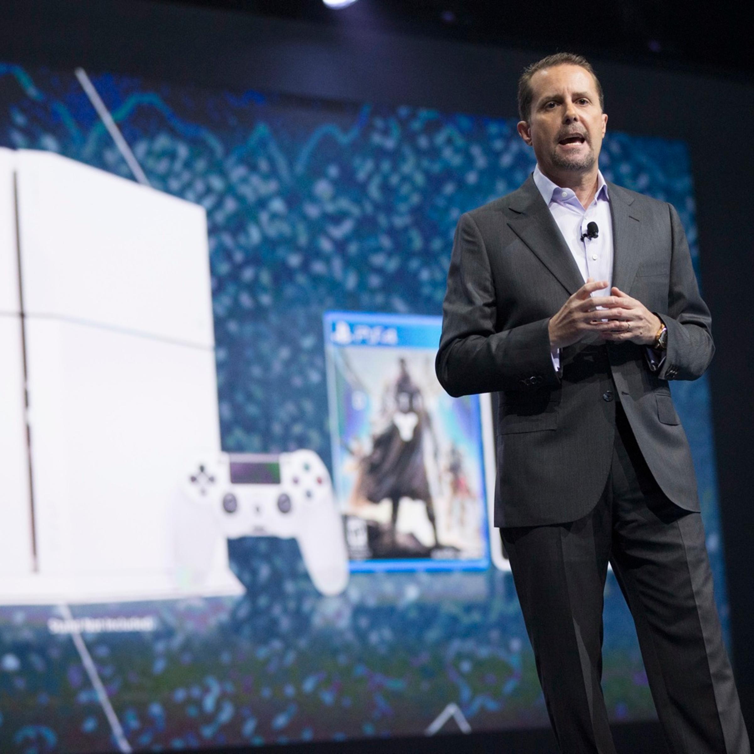 Andrew House, President and Group CEO of Sony Computer Entertainment, presents a white PlayStation 4 during a media briefing before the opening day of the Electronic Entertainment Expo, or E3, at the Memorial Sports Arena