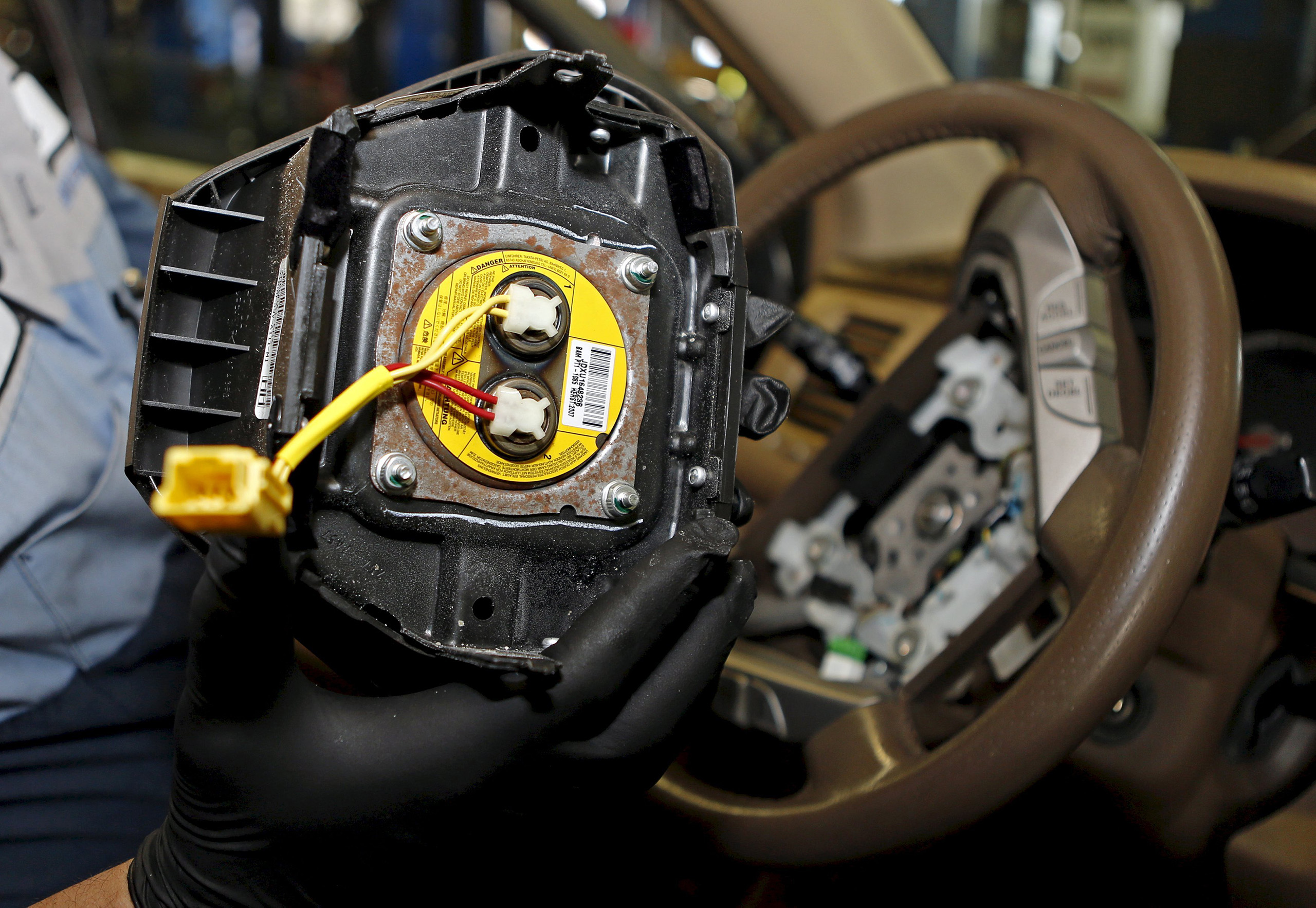 A technician holds a recalled Takata airbag inflator in Miami, Florida June 25, 2015.