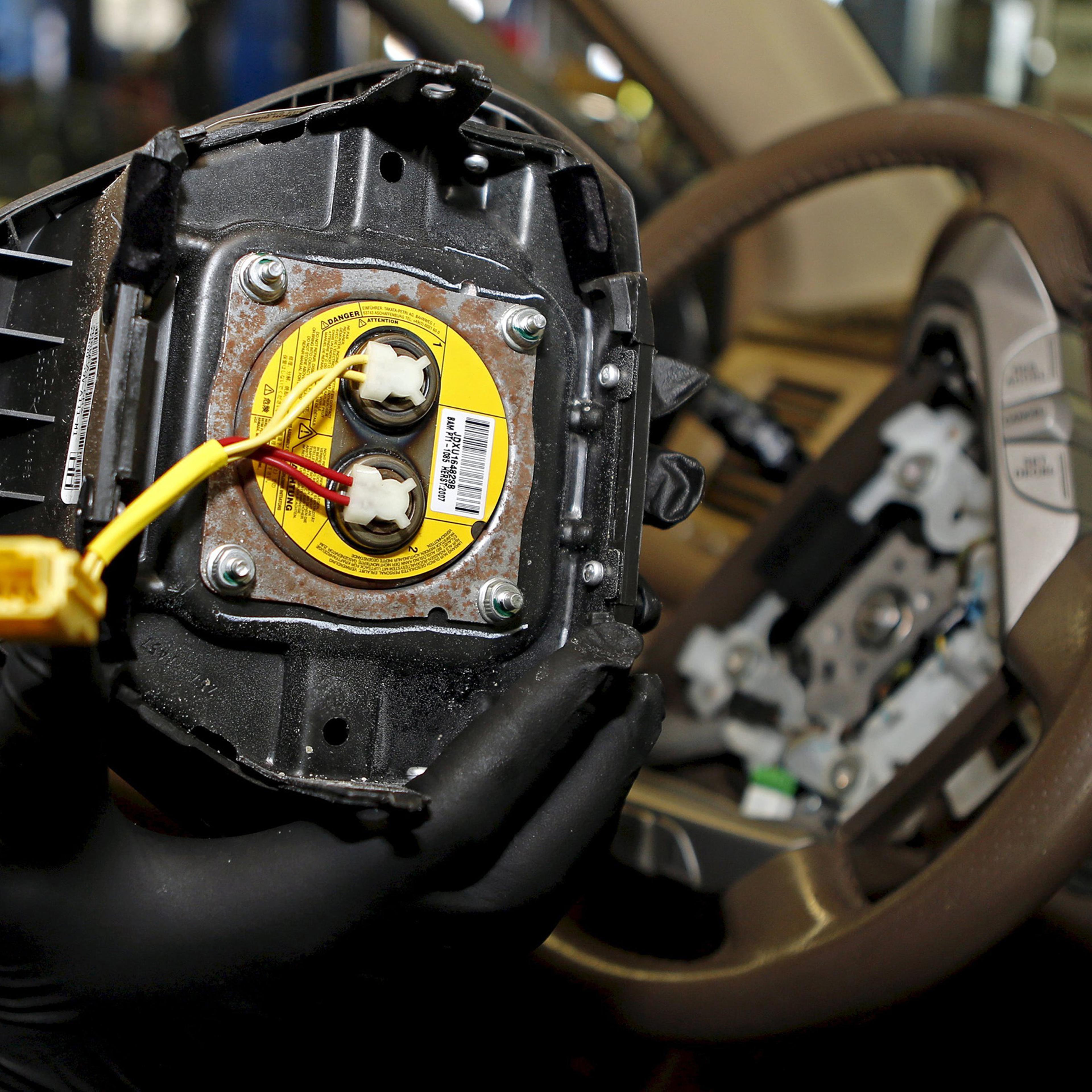 A technician holds a recalled Takata airbag inflator in Miami, Florida June 25, 2015.