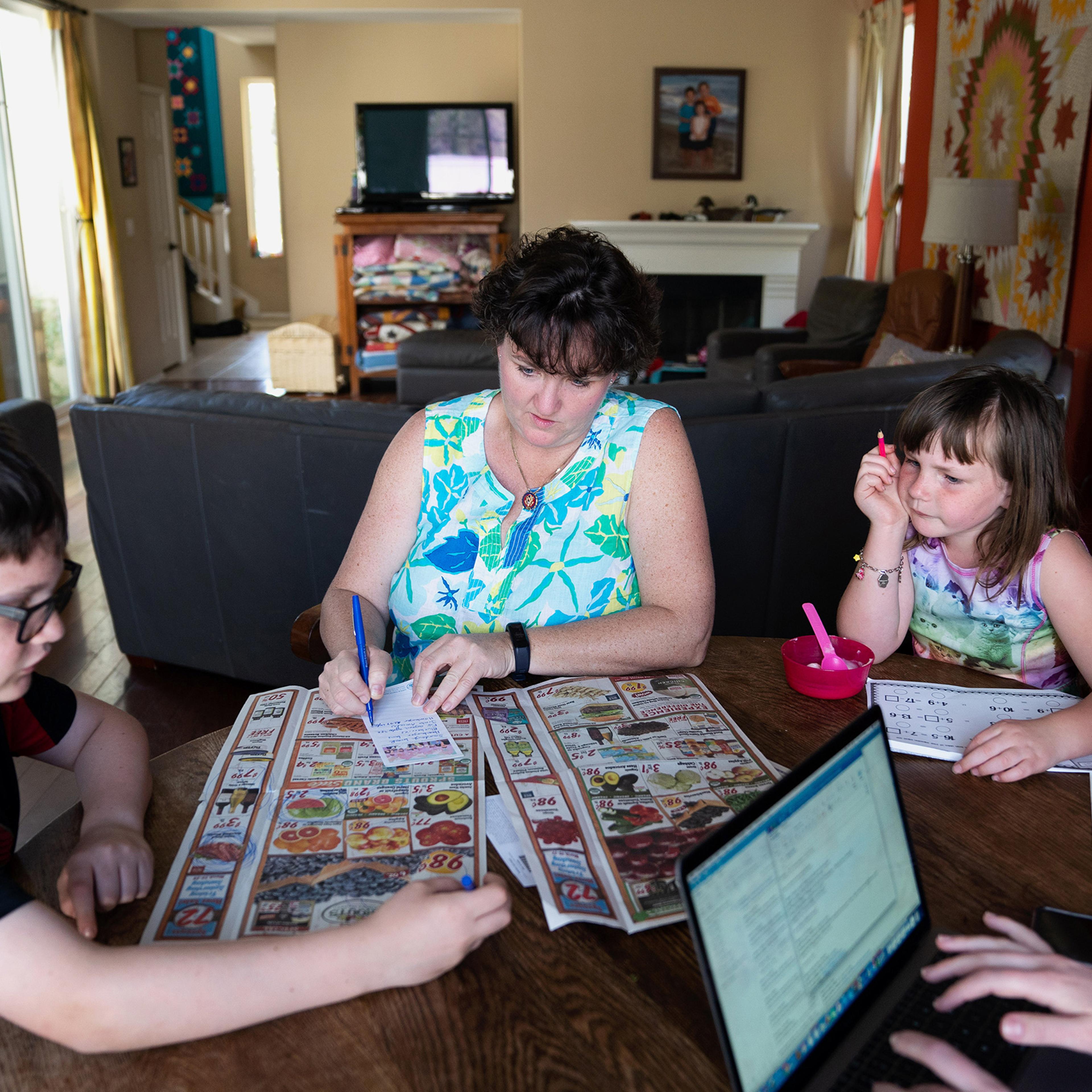 Rep. Katie Porter compiles a grocery shopping list with her son Paul and daughter Betsy at home in Irvine, Calif., on March 20, 2019