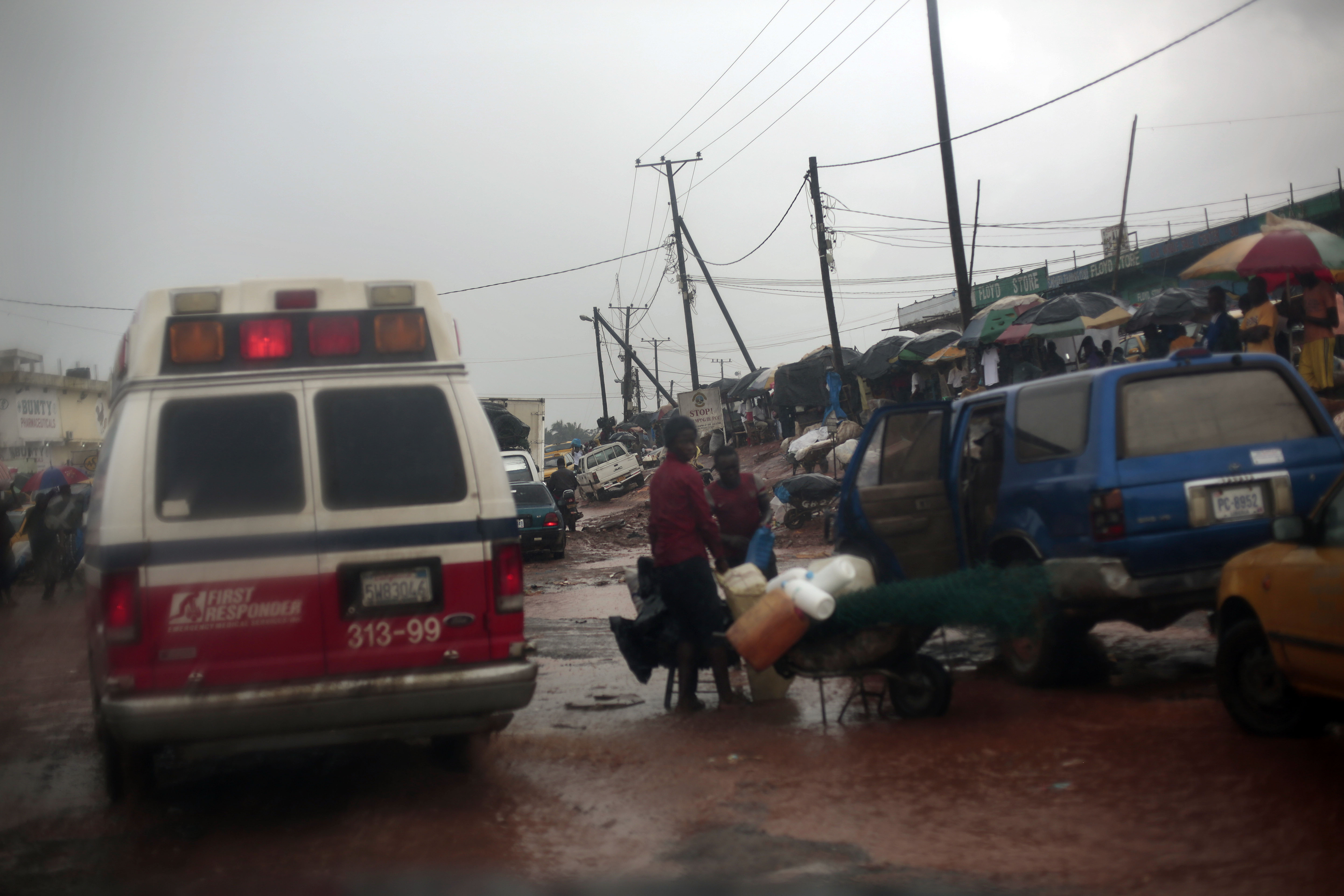 A District 13 ambulance rushes through traffic towards the Island Clinic Ebola treatment unit with six patients showing signs of Ebola infection from the village of Freeman Reserve in Monrovia, Liberia on Sept. 30, 2014.