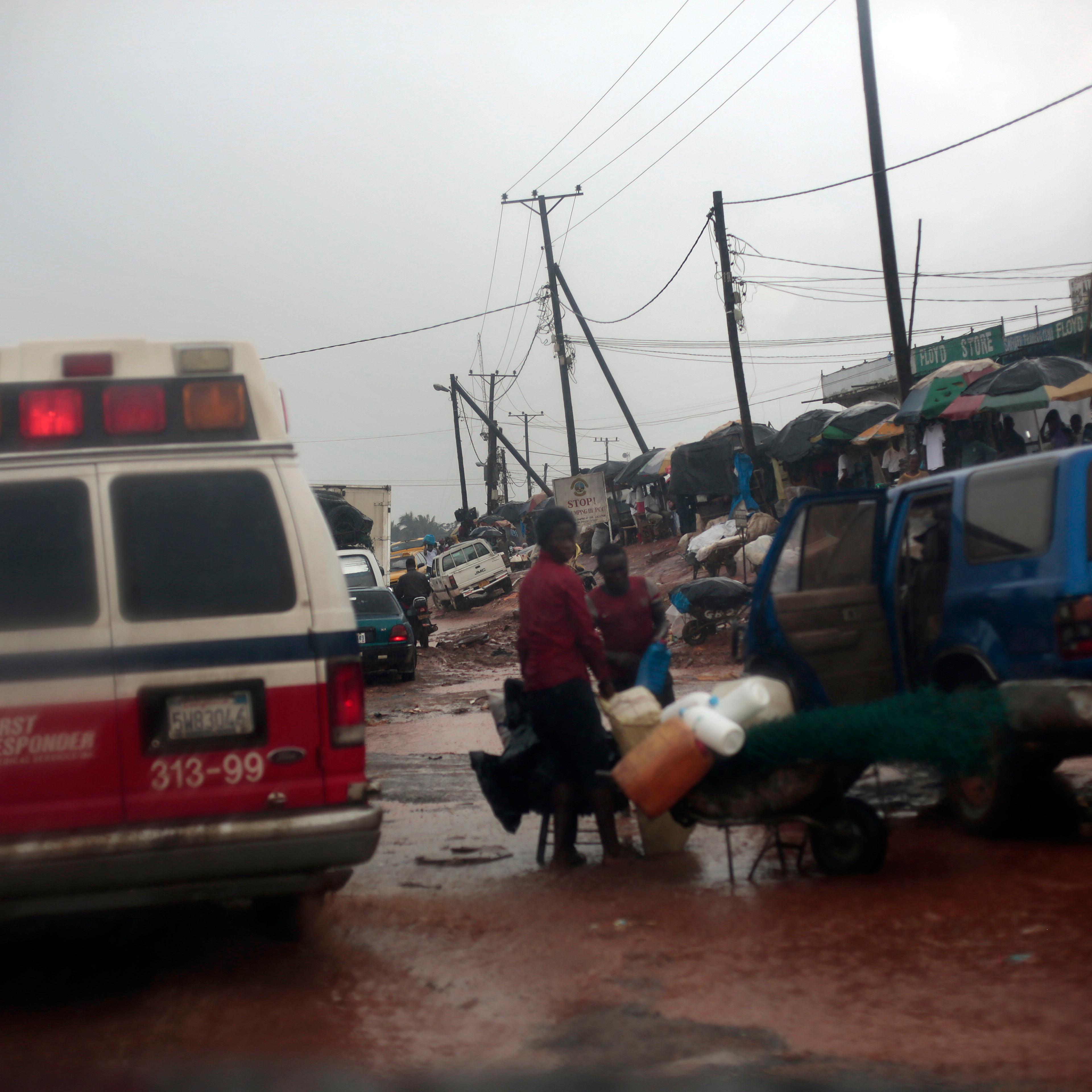 A District 13 ambulance rushes through traffic towards the Island Clinic Ebola treatment unit with six patients showing signs of Ebola infection from the village of Freeman Reserve in Monrovia, Liberia on Sept. 30, 2014.