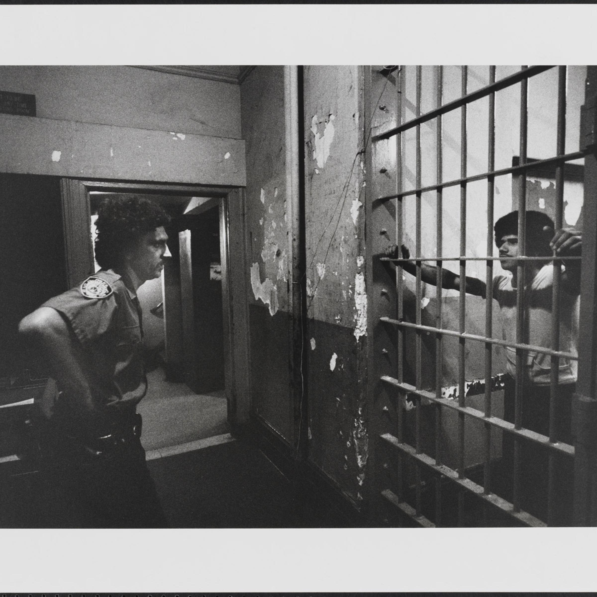 The accused and the arresting officer confront each other again in the precinct house in New York City, 1978.