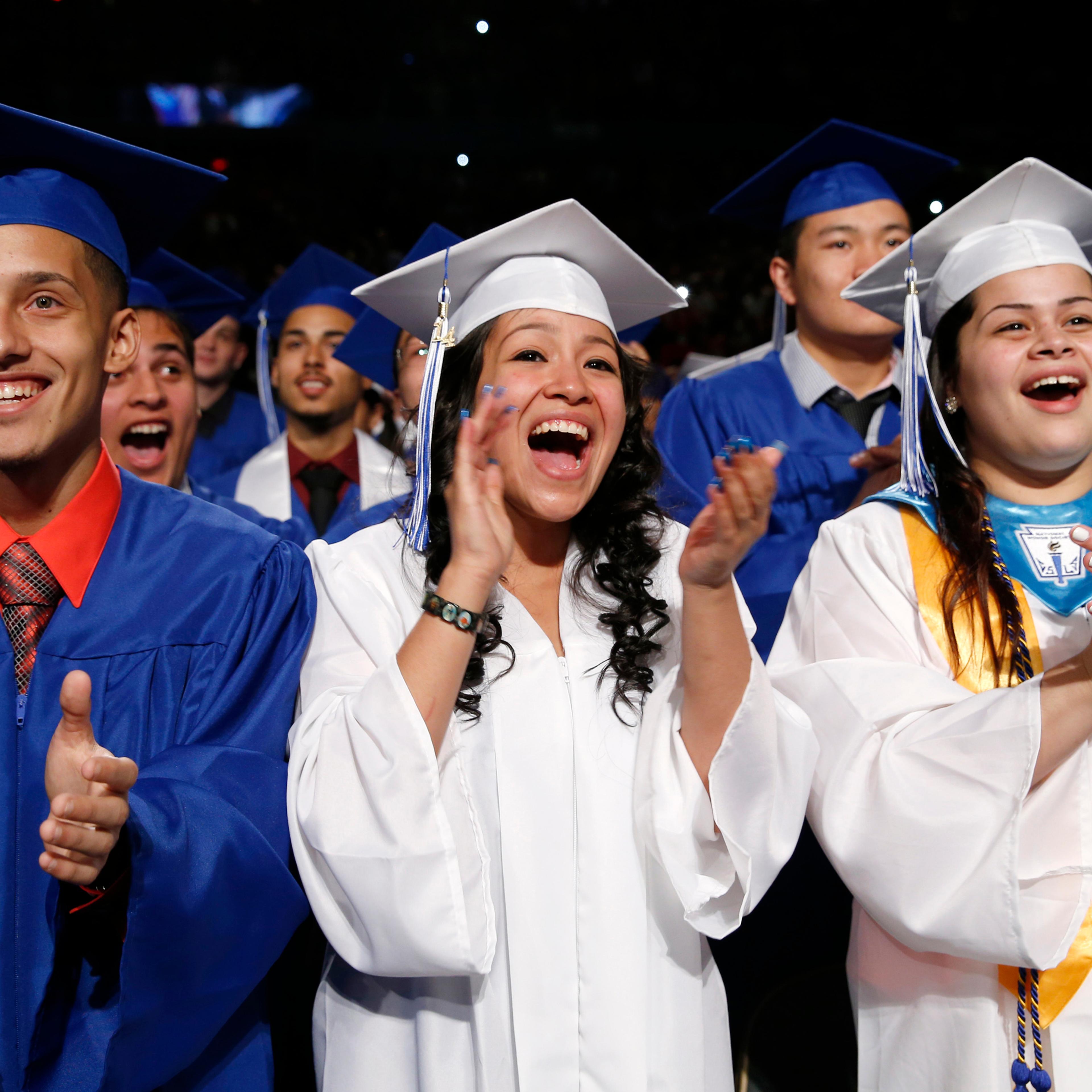 Students applaud as U.S. President Obama arrives to deliver the commencement address at the Worcester Technical High School graduation ceremony in Worcester