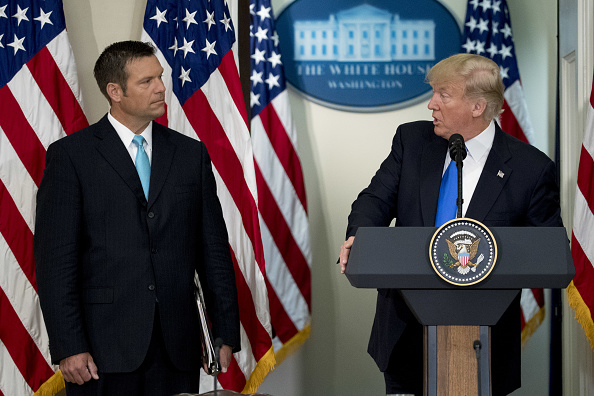 President Trump speaks as Kris Kobach, Kansas's Secretary of State, listens during the initial meeting of the Presidential Advisory Commission on Election Integrity at the Eisenhower Executive Office Building in Washington, D.C., on July 19, 2017.