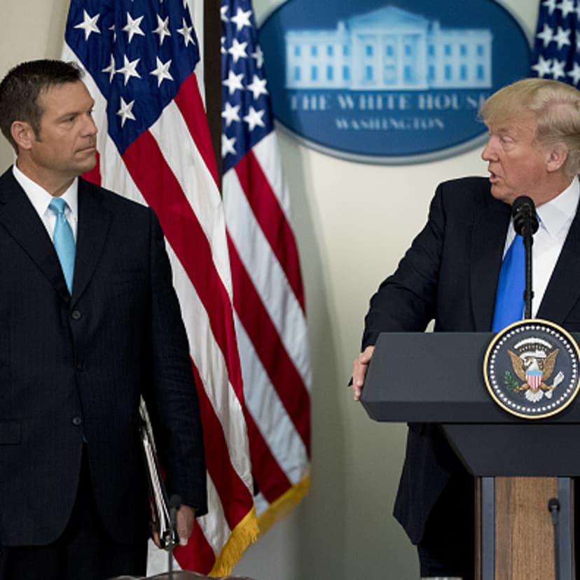 President Trump speaks as Kris Kobach, Kansas's Secretary of State, listens during the initial meeting of the Presidential Advisory Commission on Election Integrity at the Eisenhower Executive Office Building in Washington, D.C., on July 19, 2017.