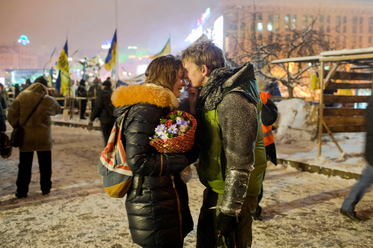 University students Sergey, 19, and Victoria, 20, a young couple from the eastern Ukrainian city of Dnipropetrovsk, embrace on Independence Square before Sergey heads off to Hrushevsky Street a short distance away where a street battle raged for a 4th da