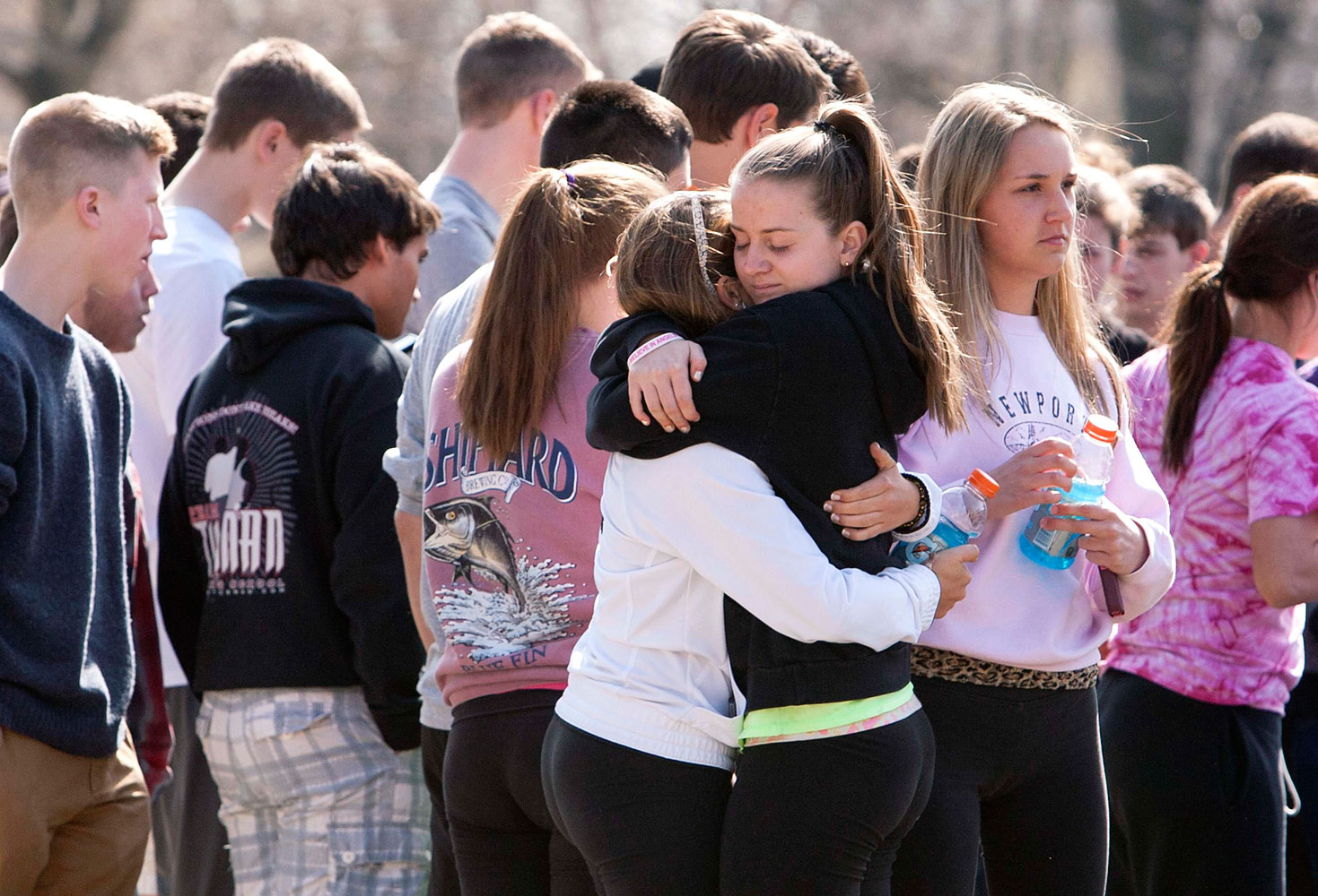 Students mourn in front of Jonathan Law High School in Milford