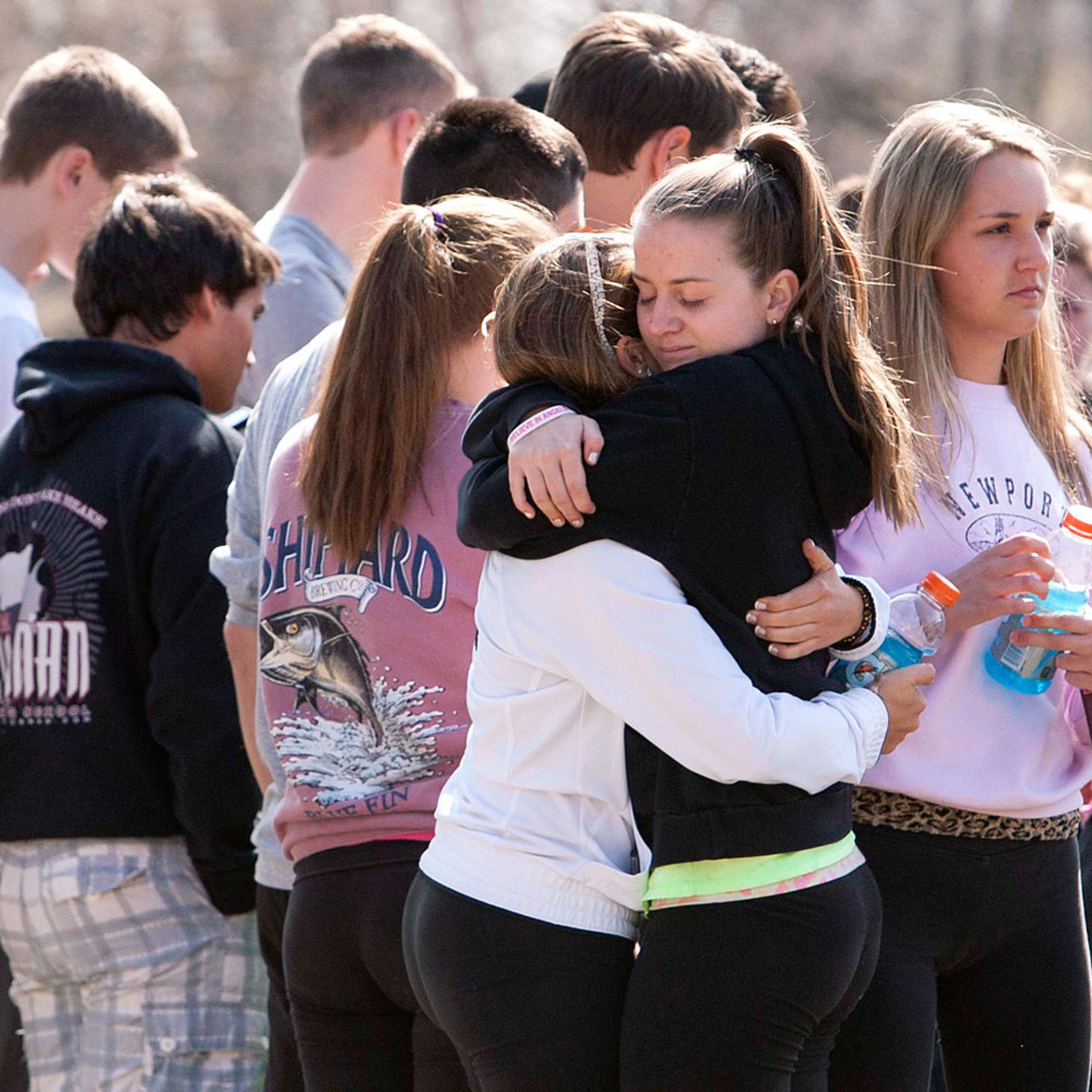 Students mourn in front of Jonathan Law High School in Milford