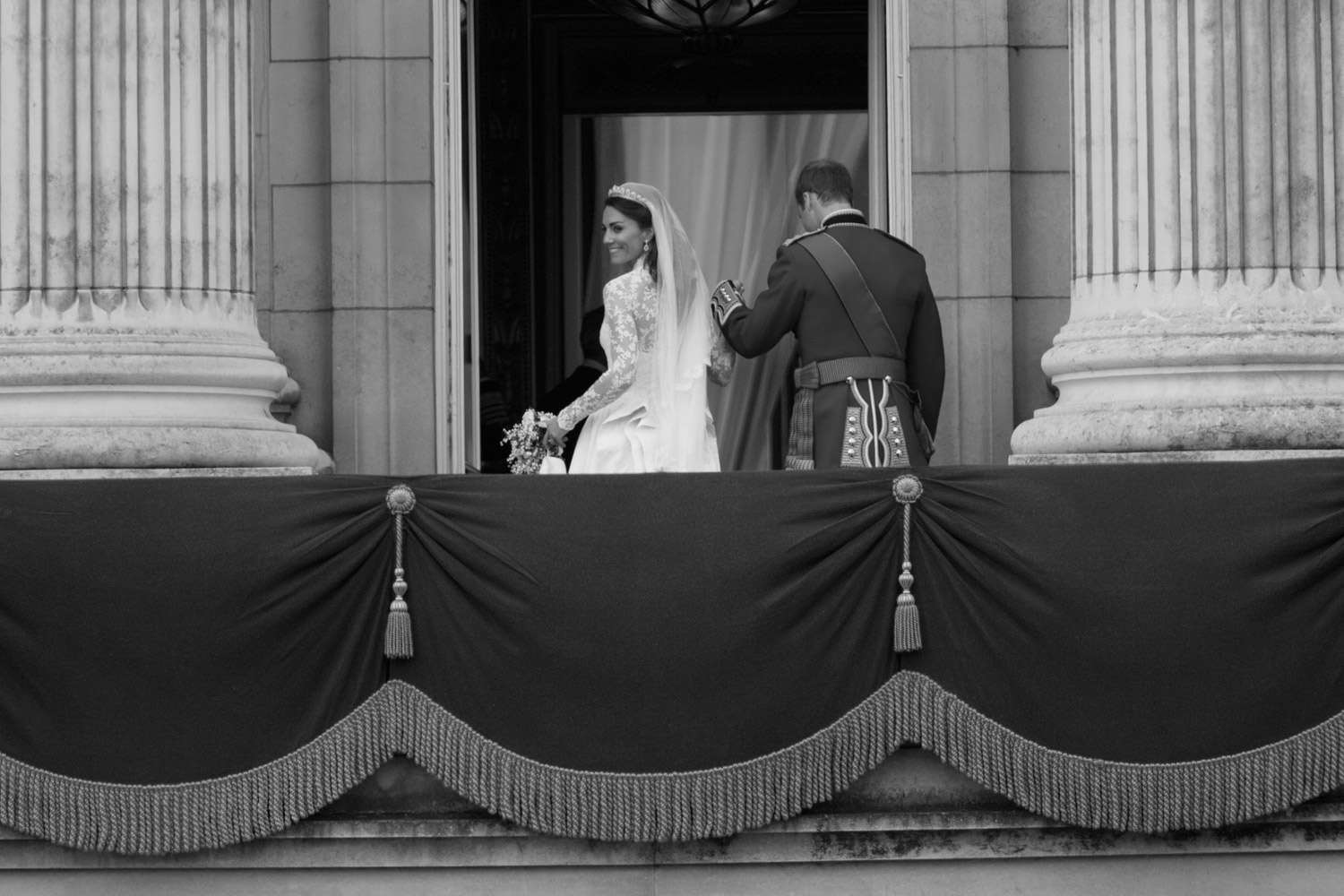 The Duchess of Cambridge gives the crowd one last glance before leaving the balcony. April 29. 2011.