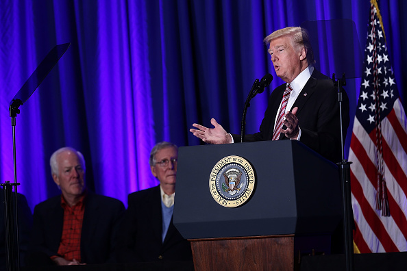 U.S. President Donald Trump (R) speaks as Senate Majority Leader Sen. Mitch McConnell (R-KY) (2nd L) and Senate Majority Whip Sen. John Cornyn (R-TX) (L) look on during a luncheon at the Congress of Tomorrow Republican Member Retreat January 26, 2017 in 