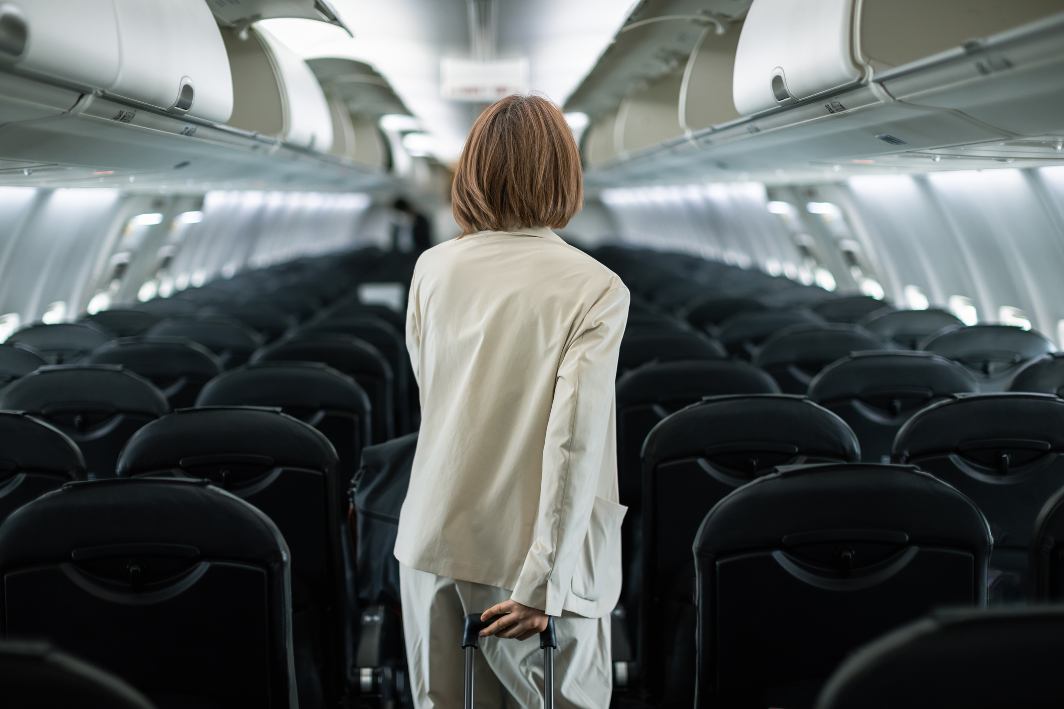 Businesswoman traveling on an airplane to a business destination