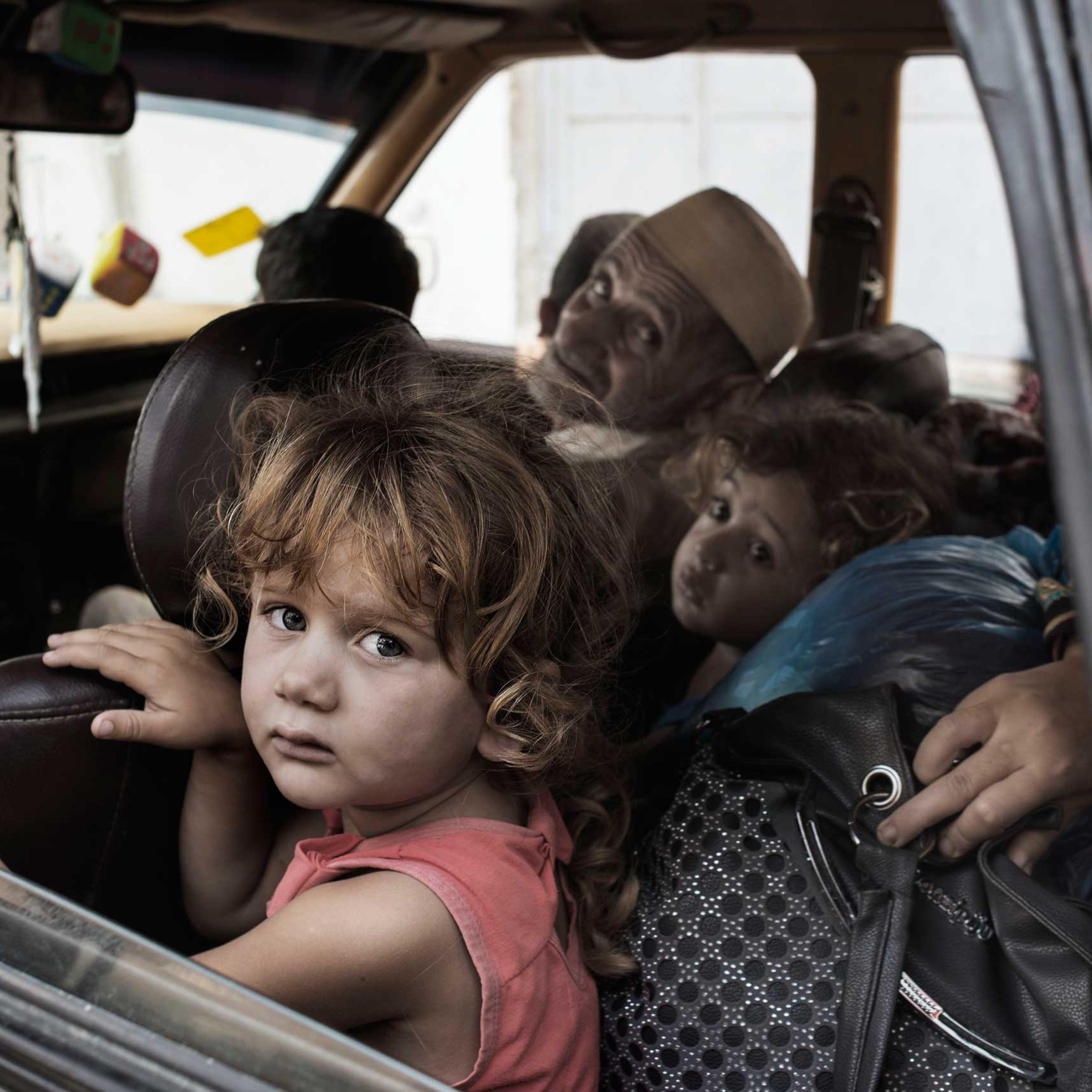 Palestinians seek shelter after evacuating their homes located near the border with Israel, July 13, 2014.