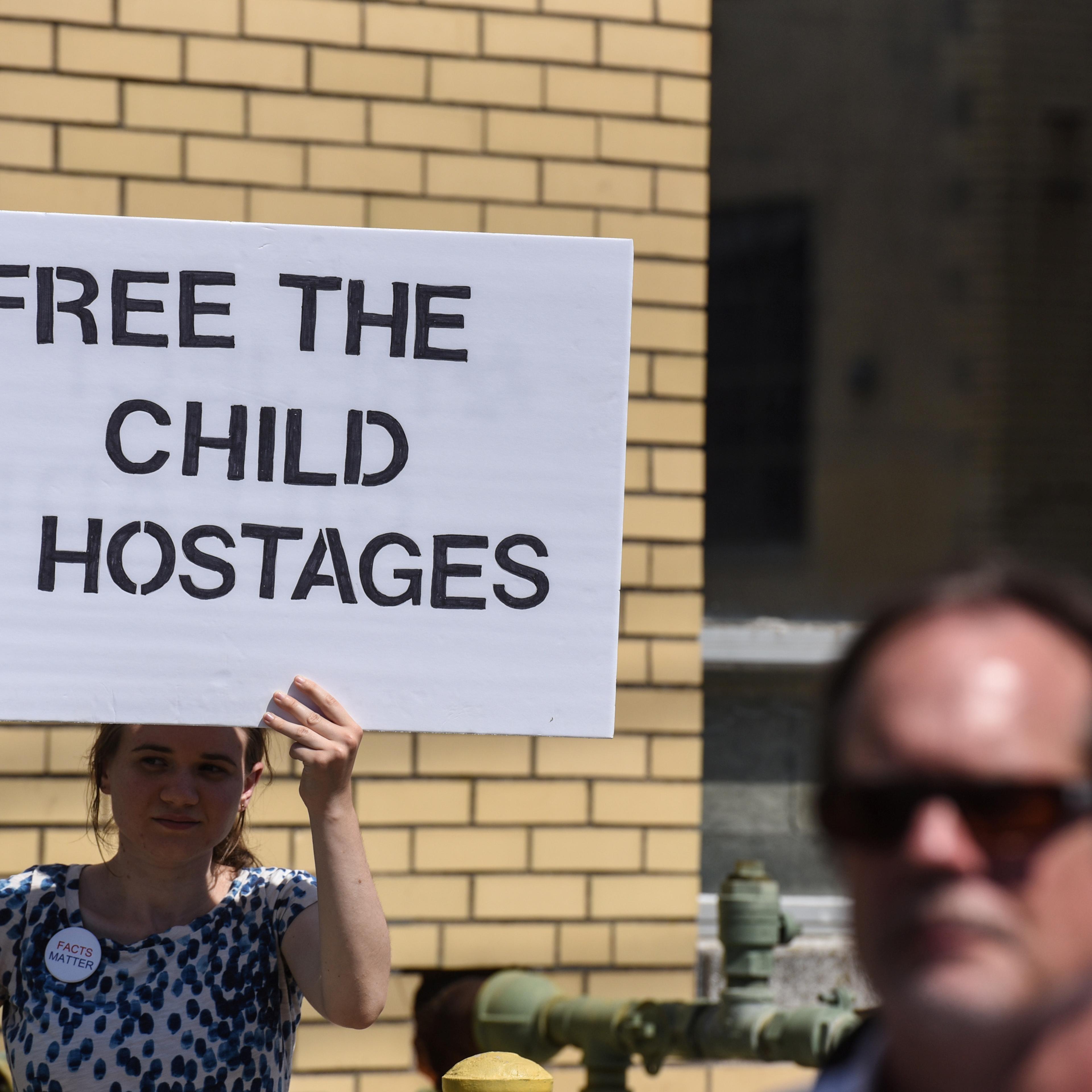 People participate in a protest against recent U.S. immigration policy of separating children from their families when they enter the United States as undocumented immigrants, in front of a Homeland Security facility in Elizabeth