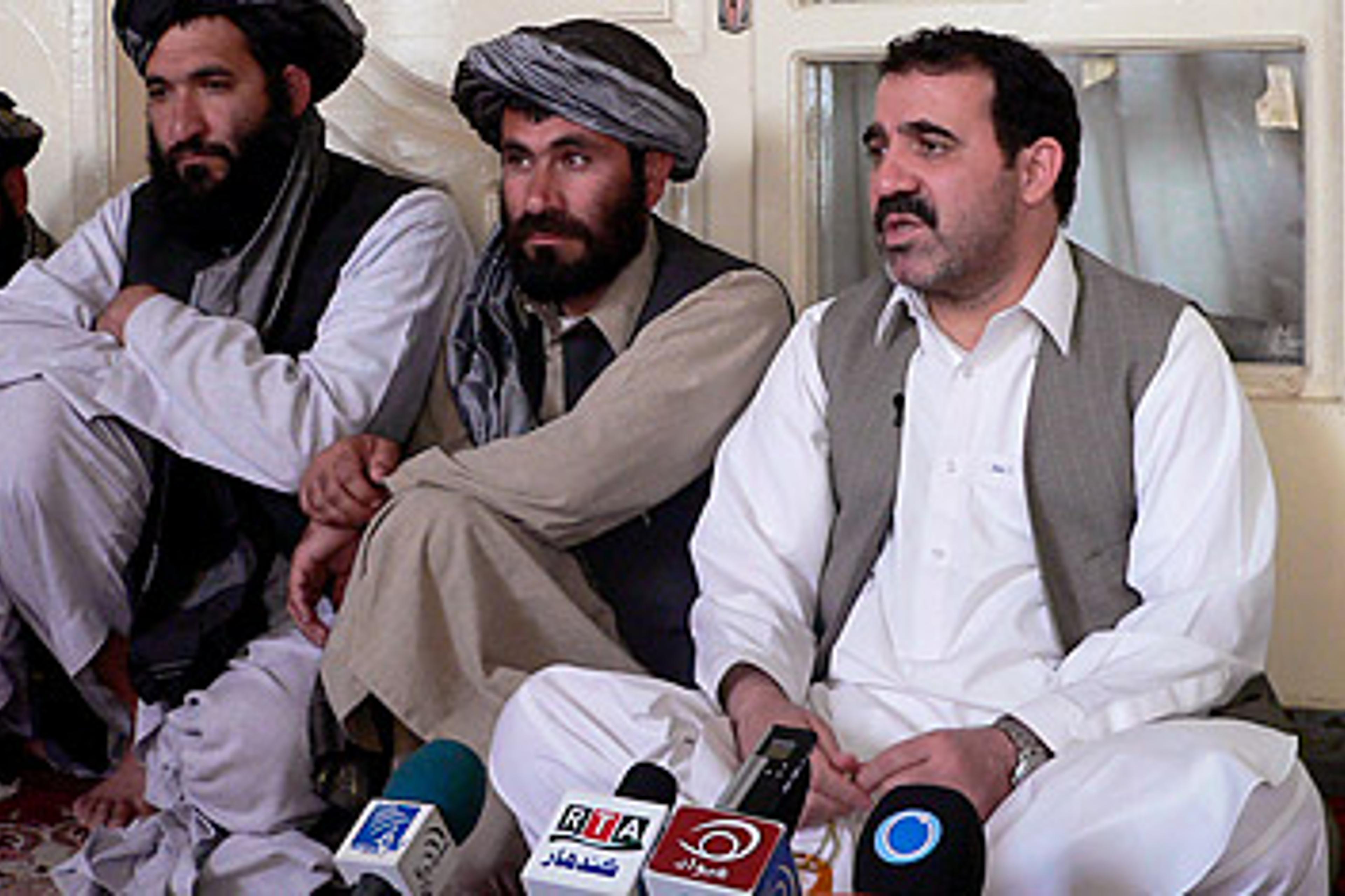 Ahmed Wali Karzai, Afghan President Hamid Karzai's half brother, right, addresses journalists