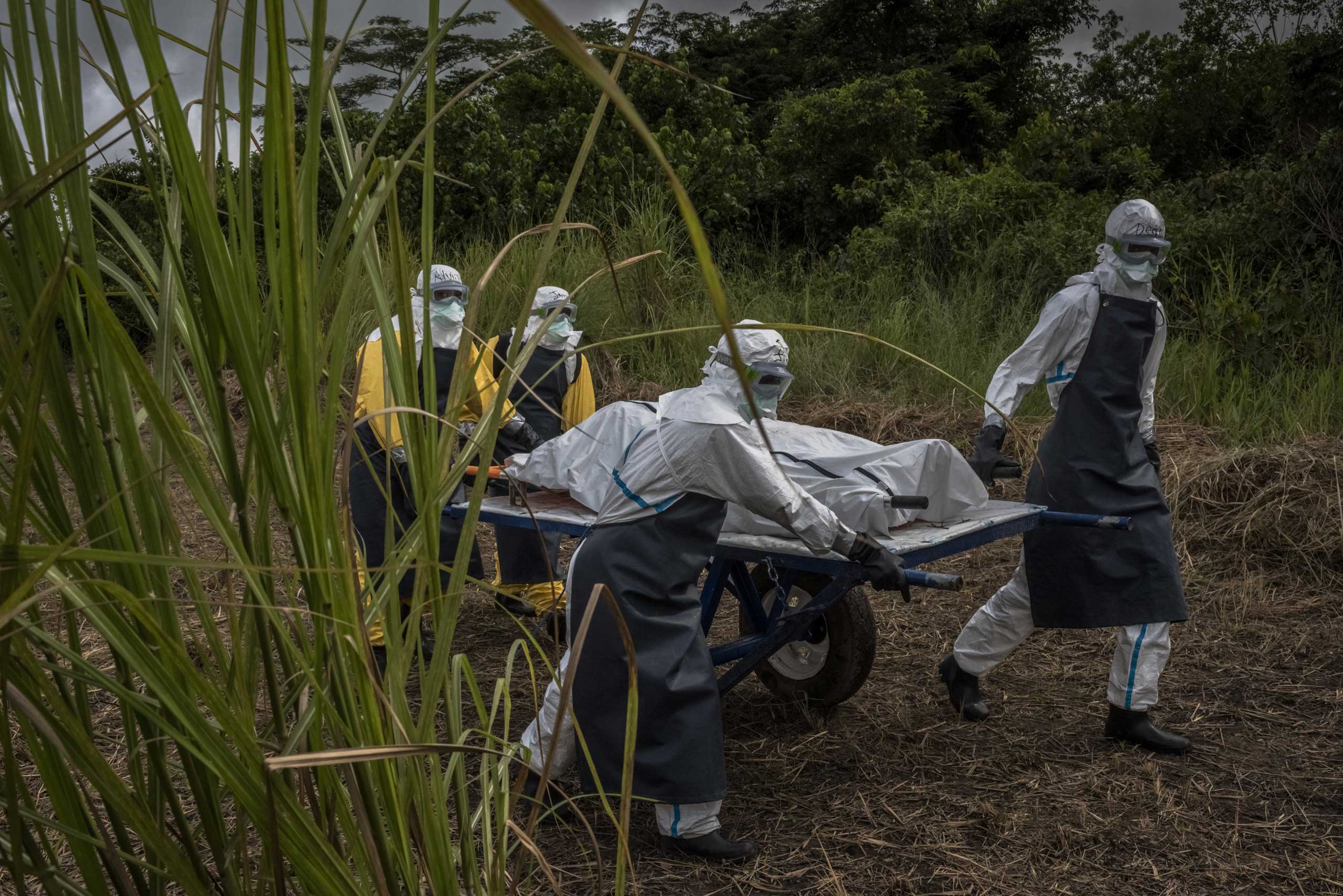 A team transports a corpse for burial near an Ebola treatment center in Suakoko, Liberia, Oct. 5, 2014.
