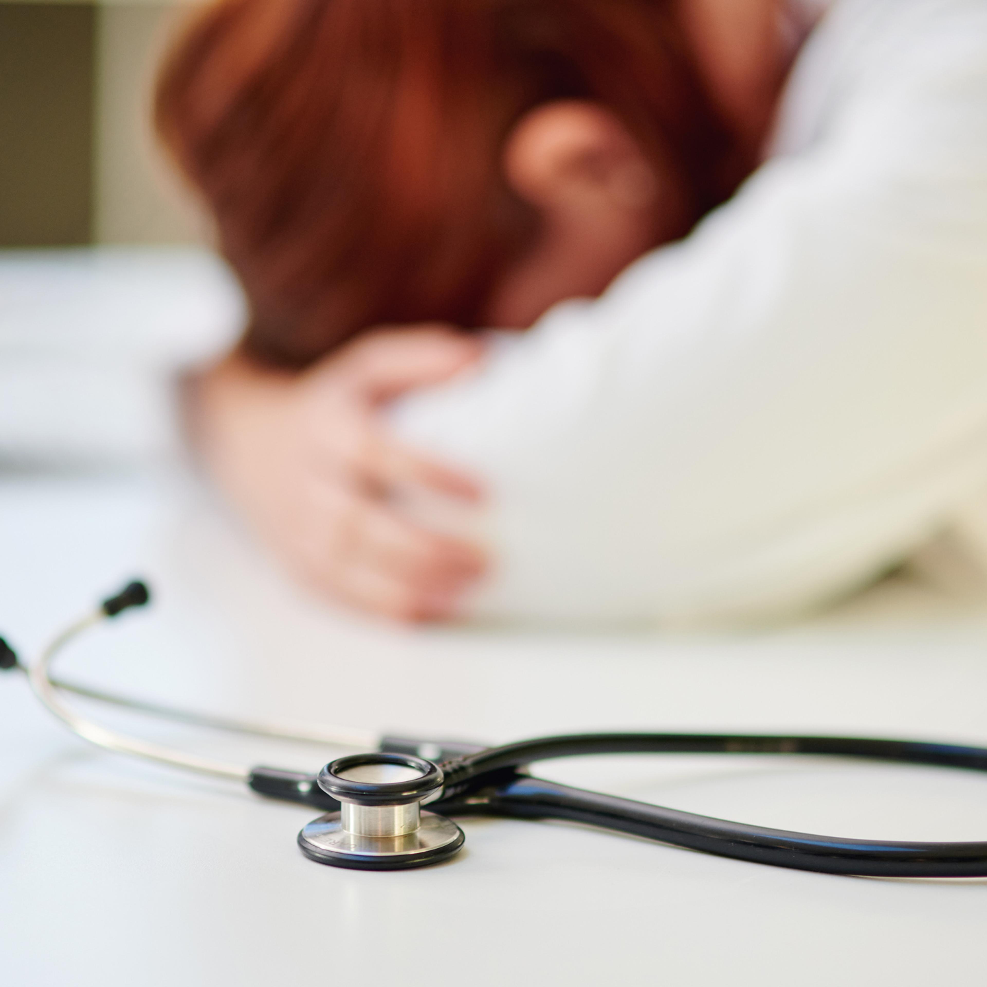 Shot of a young doctor sleeping at her desk