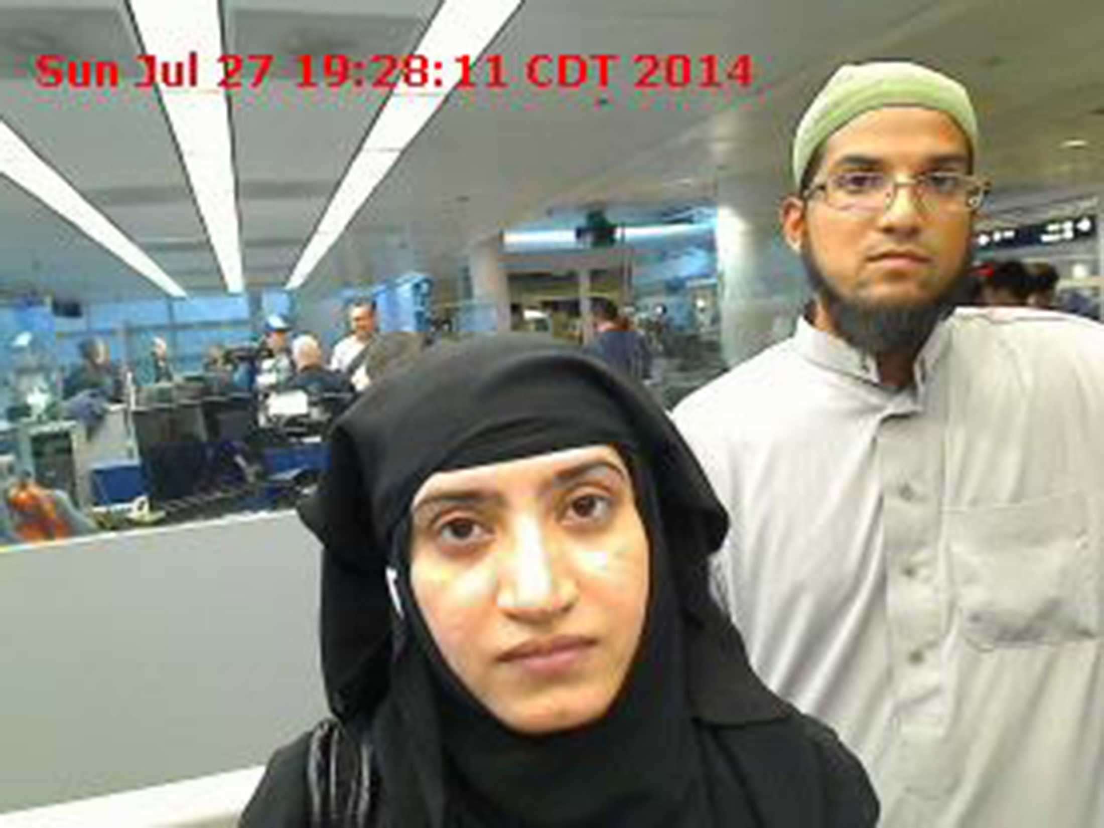 Tashfeen Malik and Syed Farook are pictured passing through Chicago's O'Hare International Airport in this July 27, 2014 handout photo
