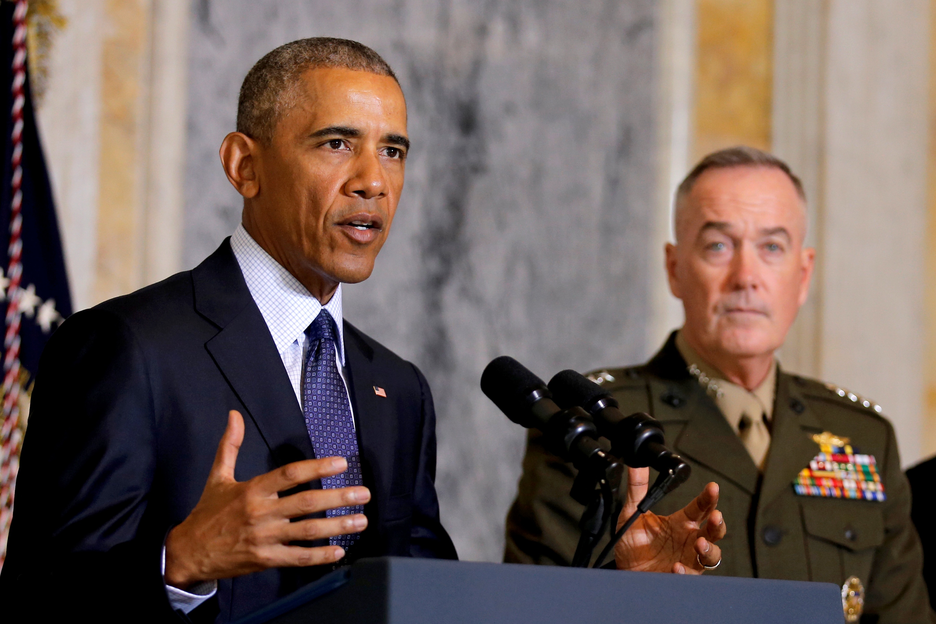 U.S. President Barack Obama delivers a statement accompanied by Director of National Intelligence James Clapper and Chairman of the Joint Chiefs of Staff General Joseph Dunford after a meeting with Obama's national security team