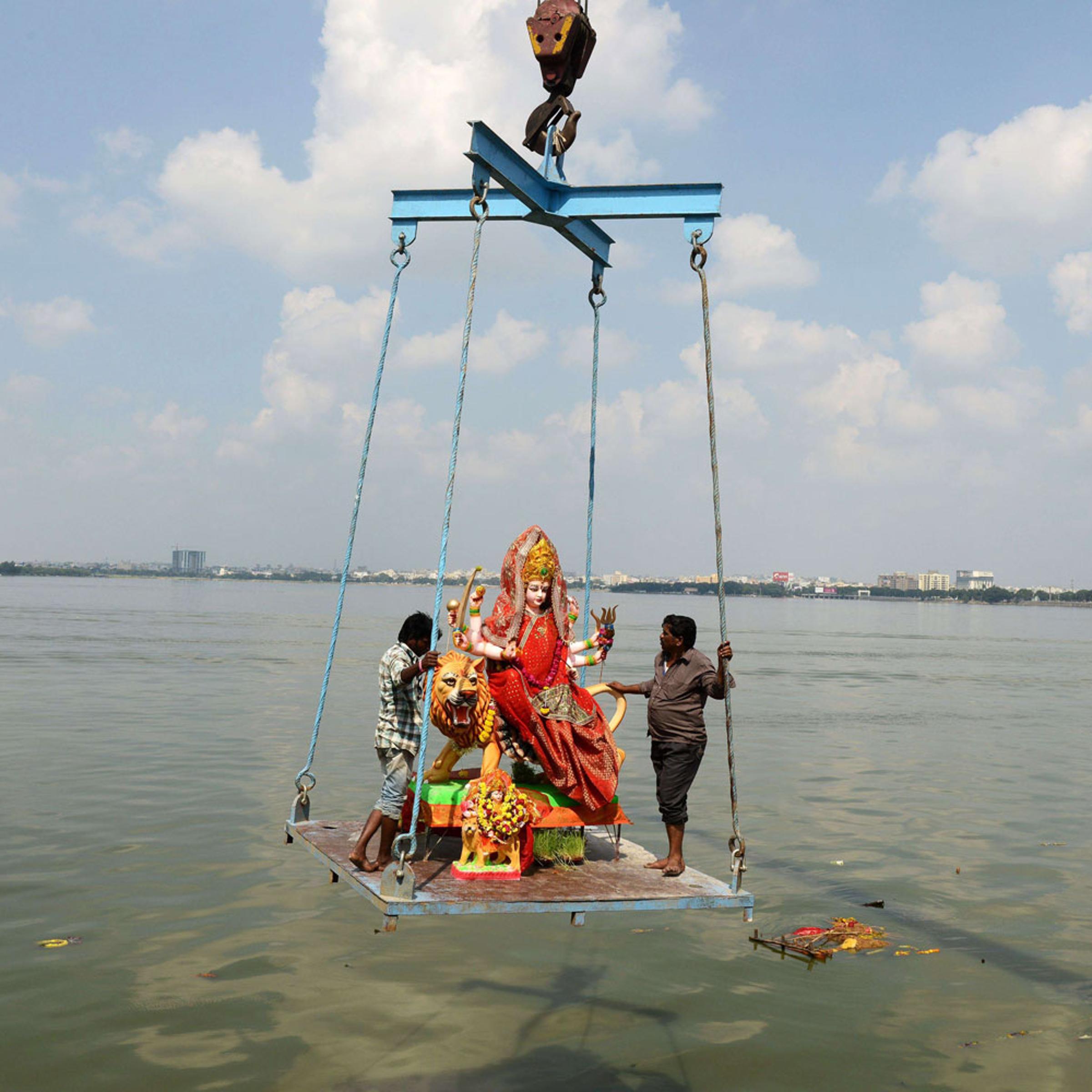 Indian workers immerse an idol of Hindu goddess Durga in the Hussainsagar lake on the occasion of the Dussehra-Vijaya Dashami Festival in Hyderabad.