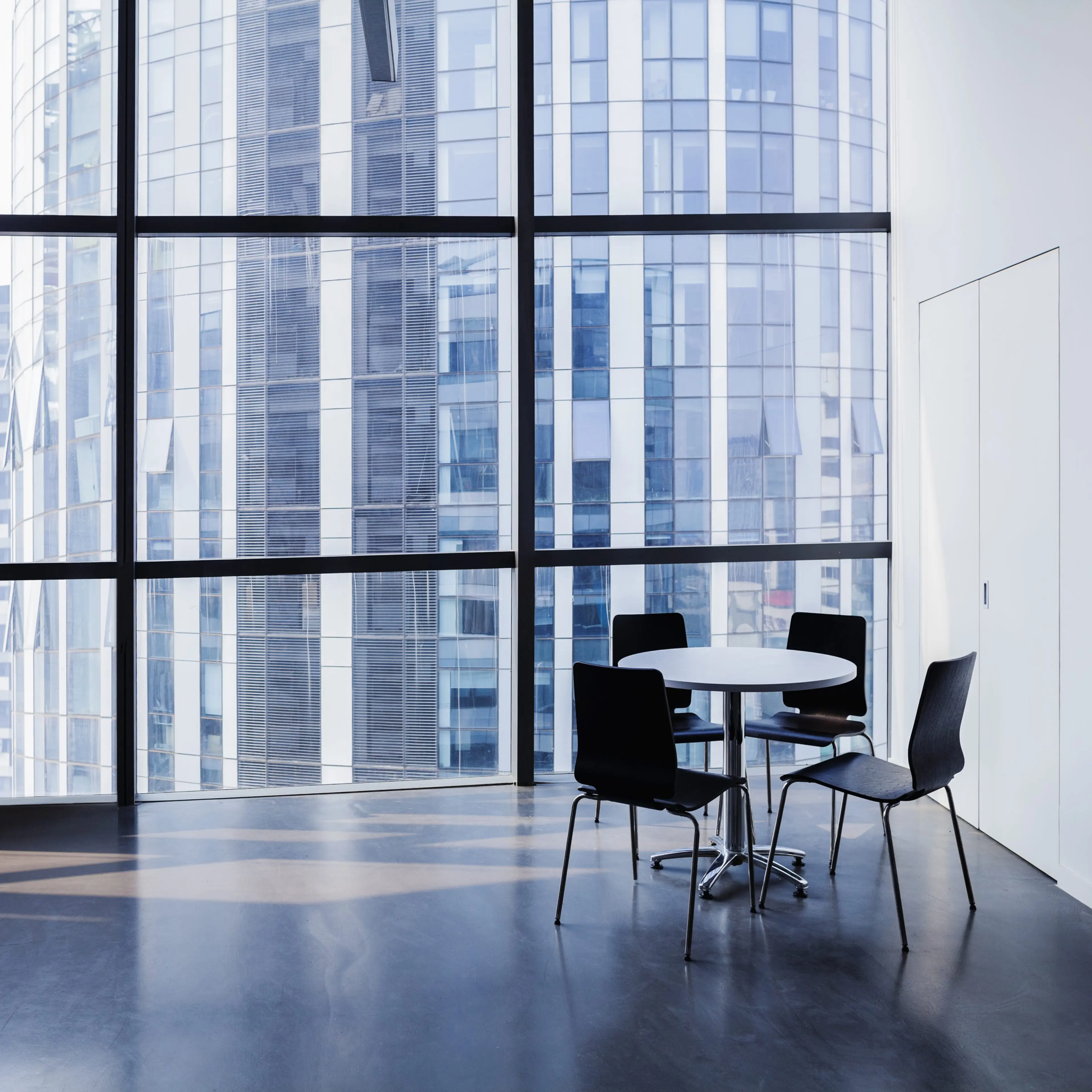 Empty modern office with table and four chairs