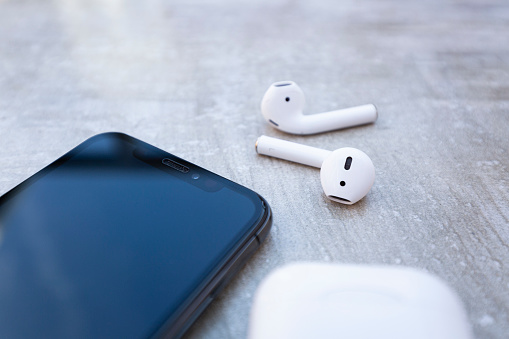 Apple iPhone XS with AirPods and case