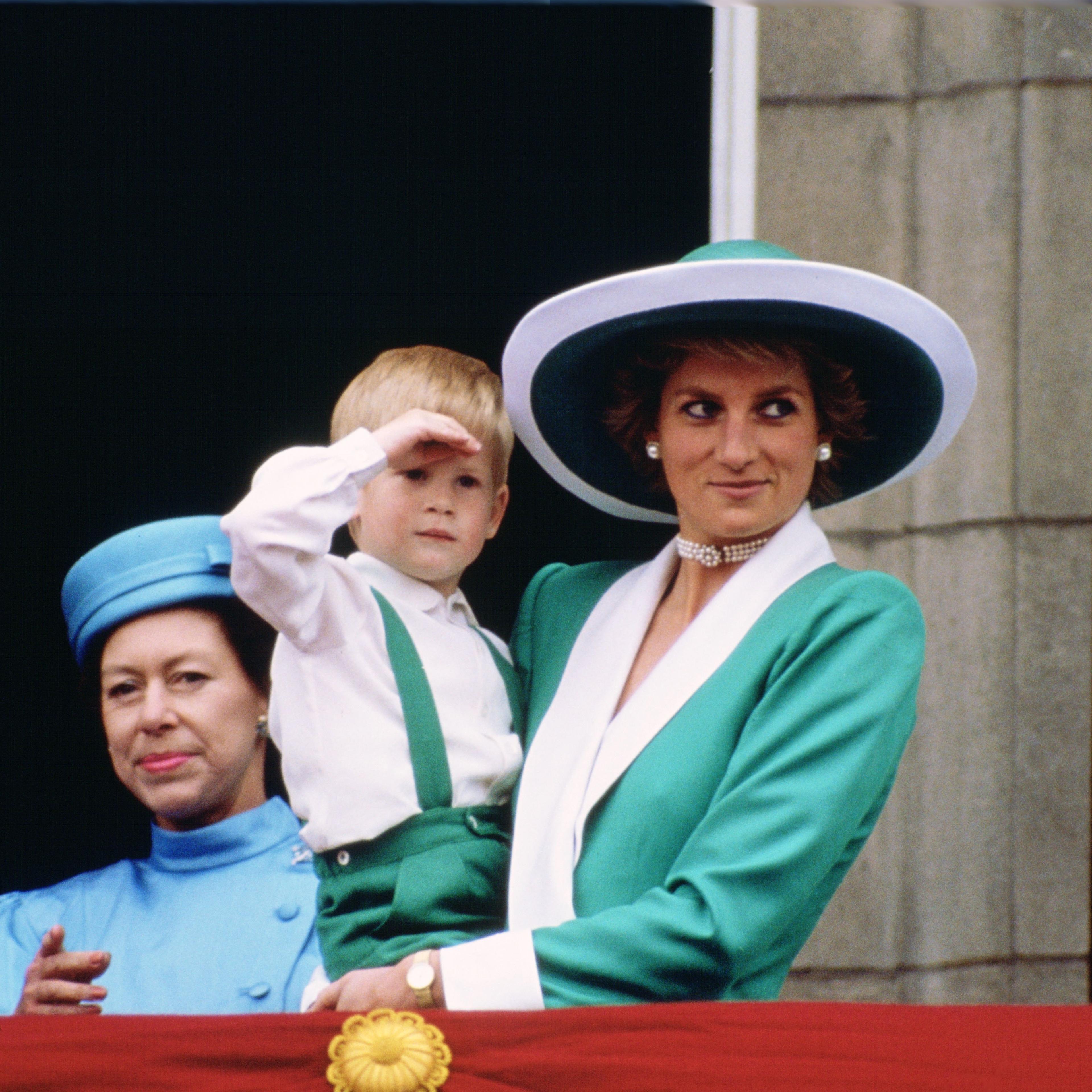 Diana, Princess of Wales, holding a young Prince Harry in he