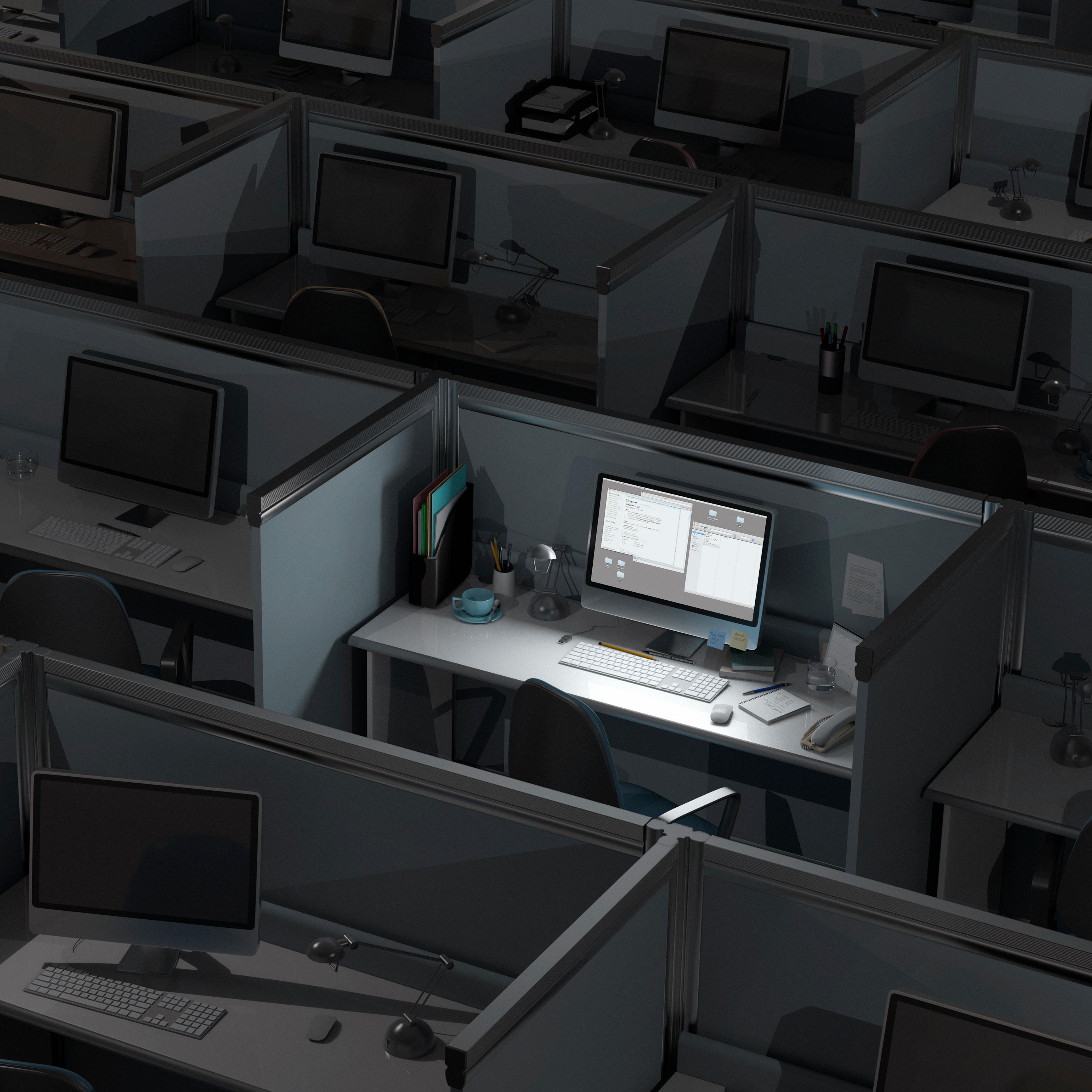 Dark office with many computers, one lit up