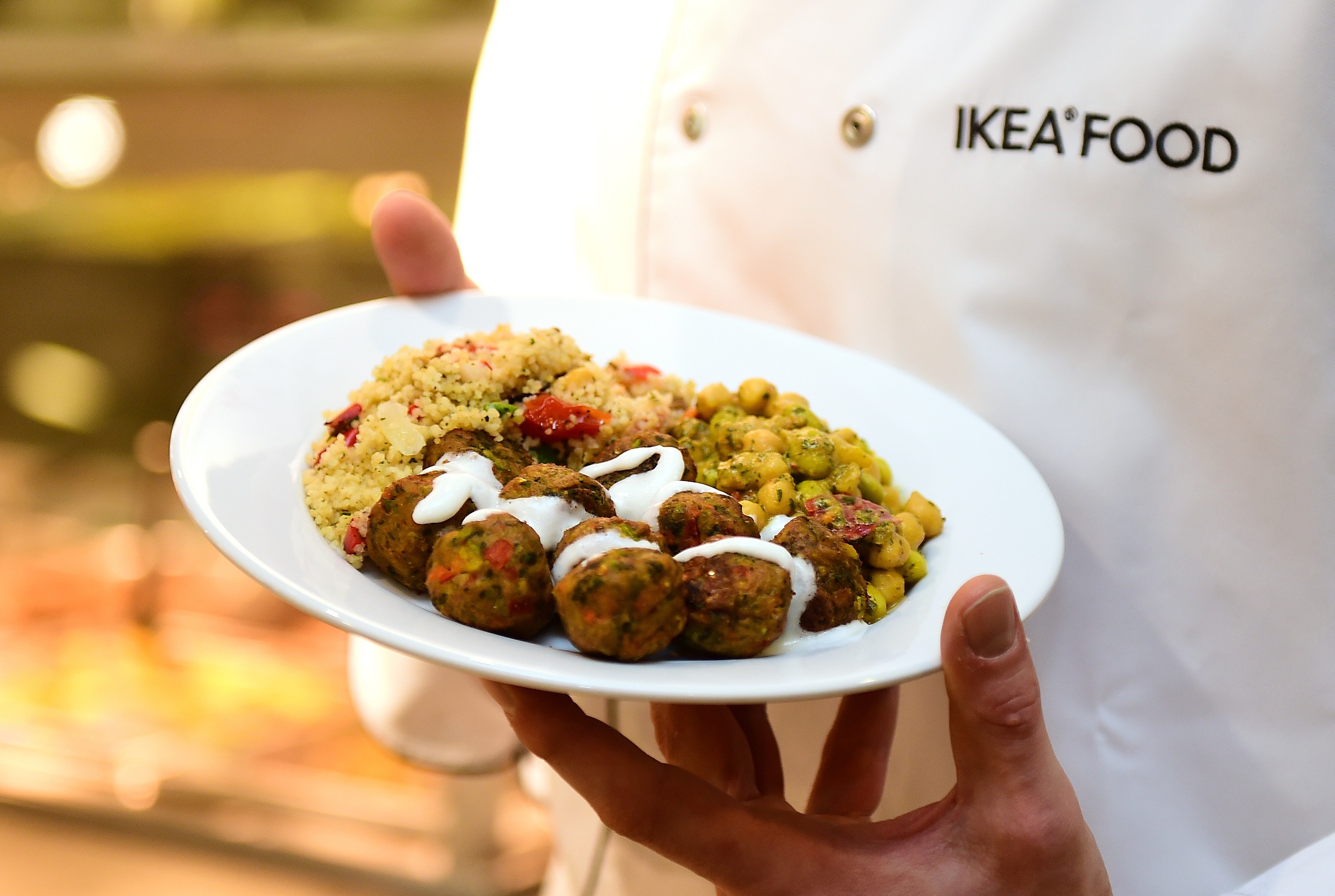 An IKEA employee displays the new IKEA vegetarian meatballs, during a worldwide launch at IKEA Anderlecht, on April 8, 2015.