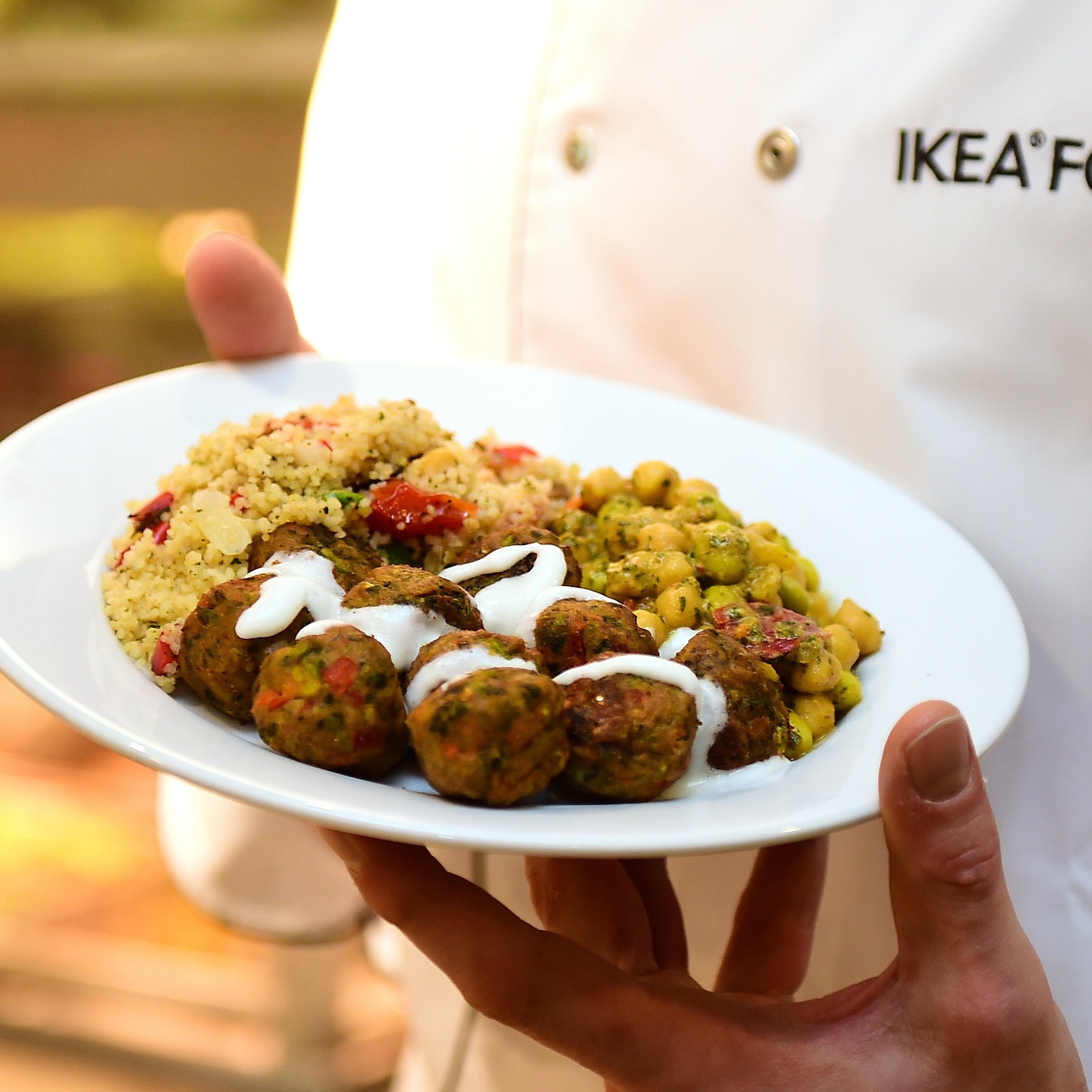 An IKEA employee displays the new IKEA vegetarian meatballs, during a worldwide launch at IKEA Anderlecht, on April 8, 2015.