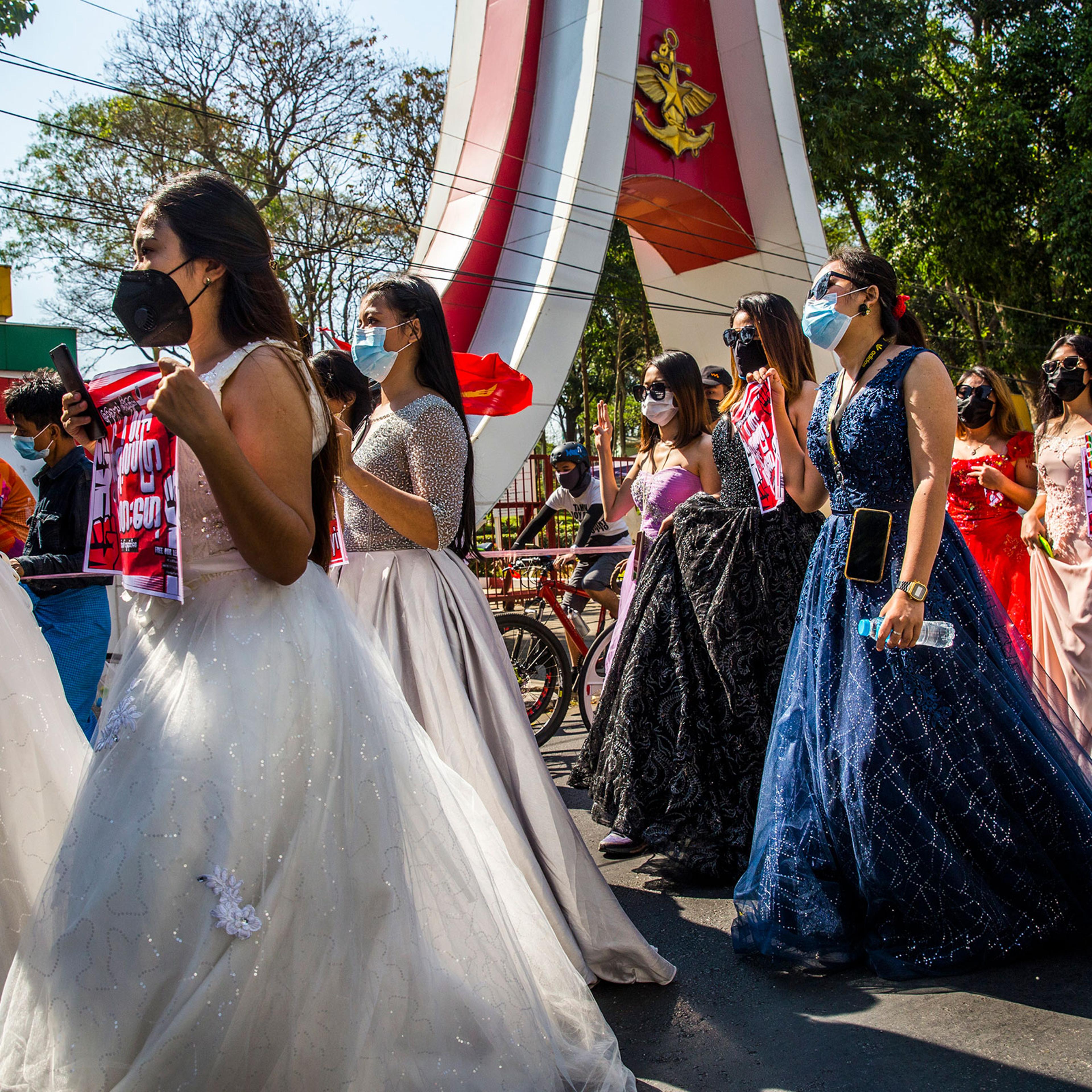 A group of women wearing formal gowns march in Yangon, Myanmar, on Feb. 10, 2021, to protest against the military coup.