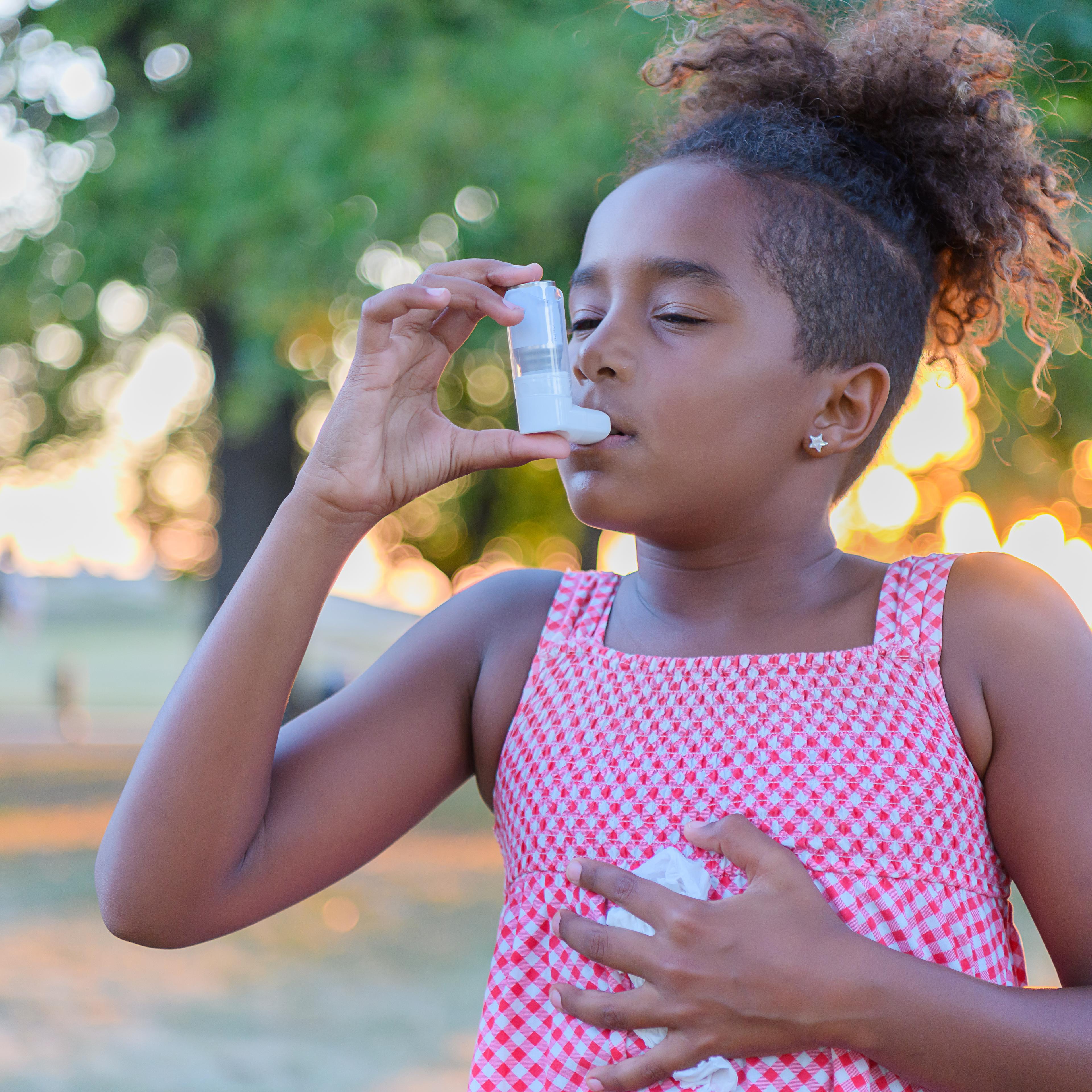 Beautiful Little African-American Girl is Having Asthmatic Problems Outside in Nature.