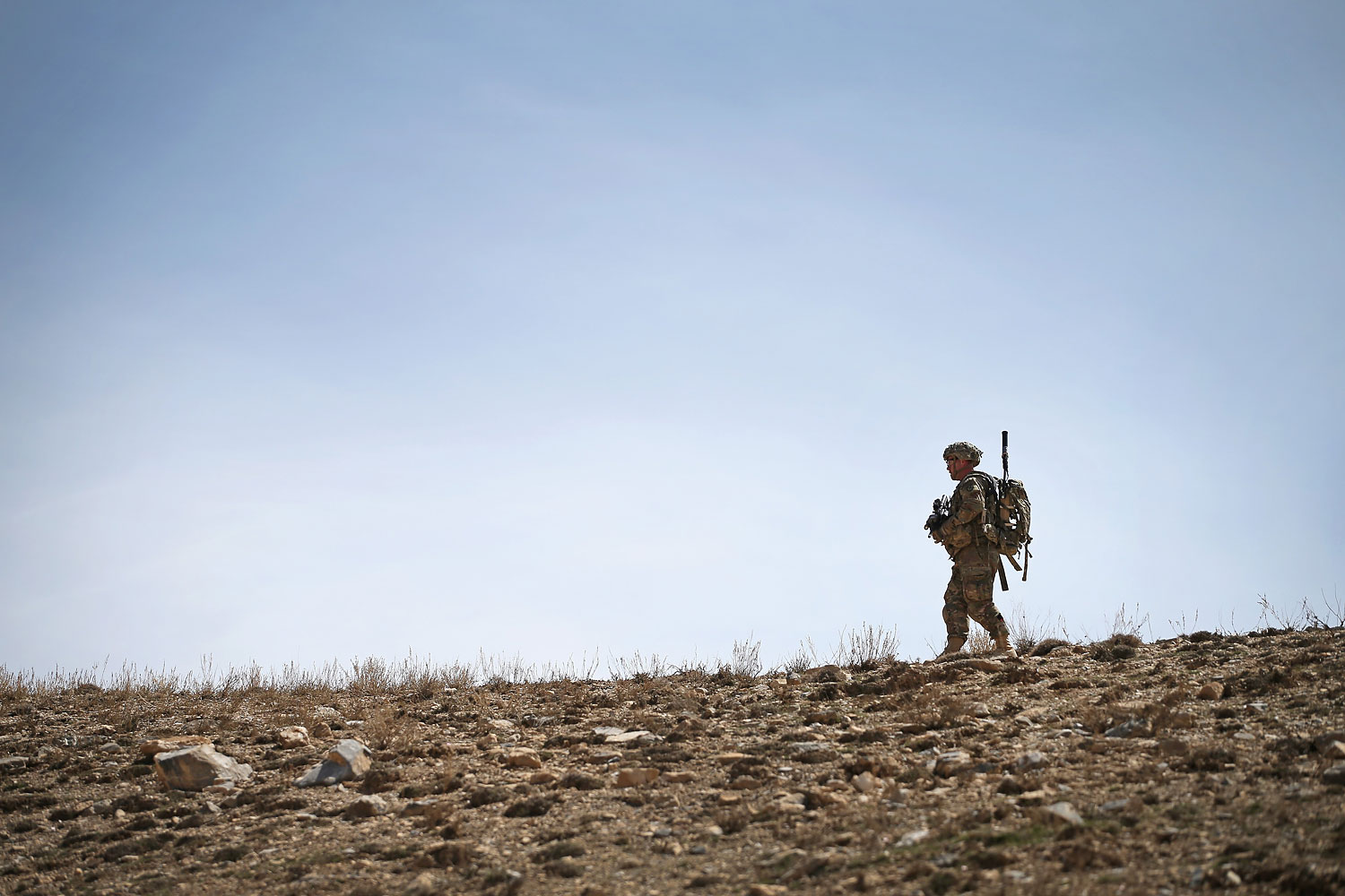 U.S. soldiers walks along a ridgeline during a patrol up a mountainside near Forward Operating Base Shank on March 31, 2014 near Pul-e Alam, Afghanistan.