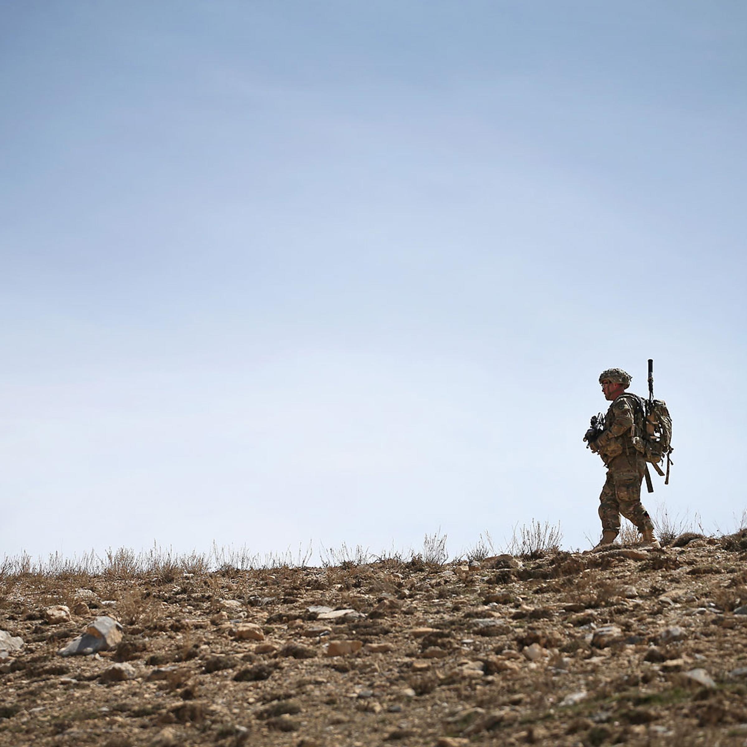 U.S. soldiers walks along a ridgeline during a patrol up a mountainside near Forward Operating Base Shank on March 31, 2014 near Pul-e Alam, Afghanistan.